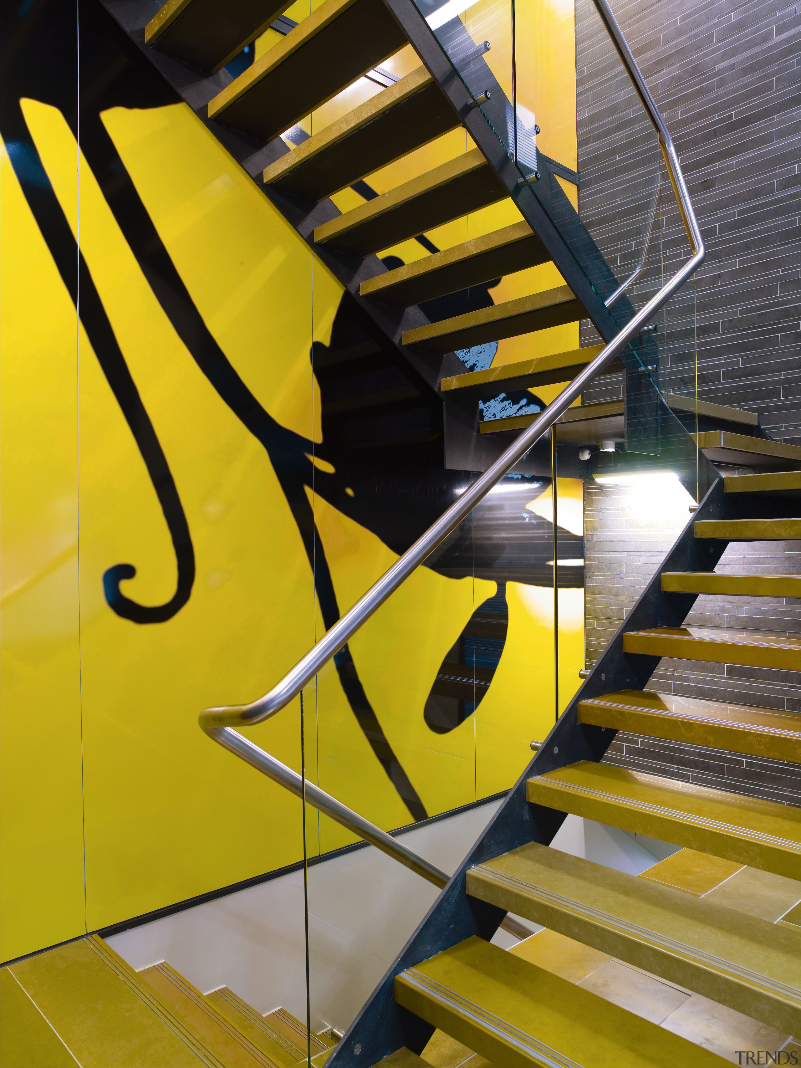 A view of  the Szencorp offices in angle, architecture, daylighting, handrail, line, stairs, yellow, orange, black