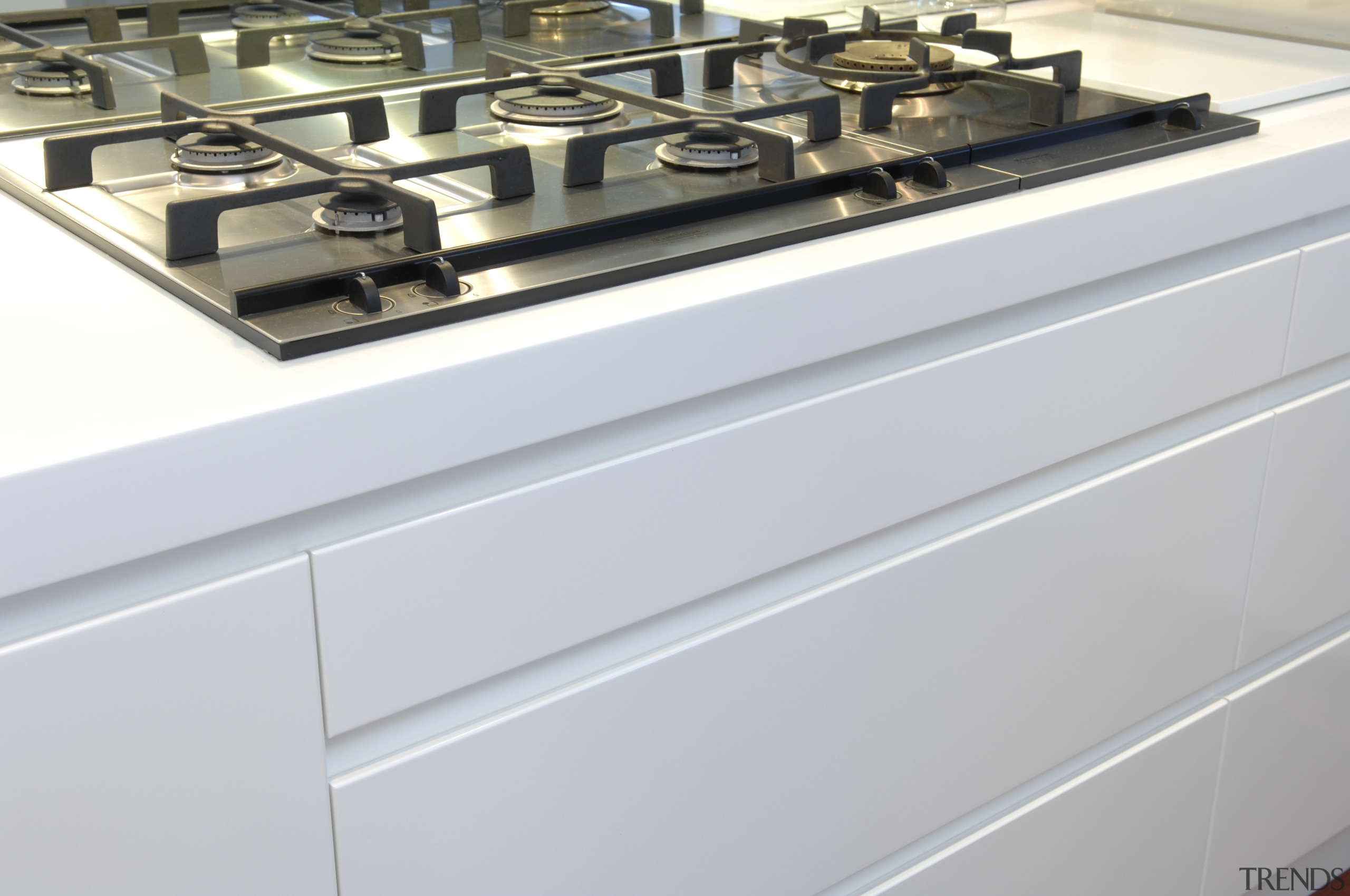 View of a gas cooktop which is part countertop, gray