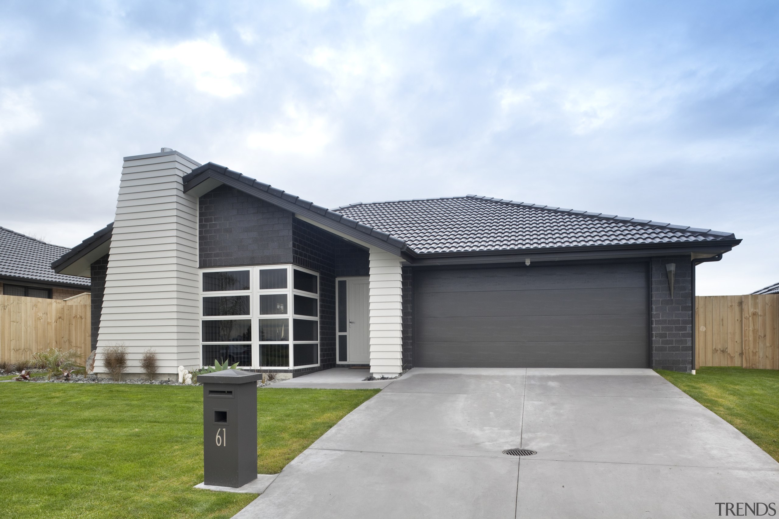 Exterior of single-storey house, dark stone cladding, and building, elevation, estate, facade, home, house, property, real estate, residential area, roof, siding, suburb, white, gray