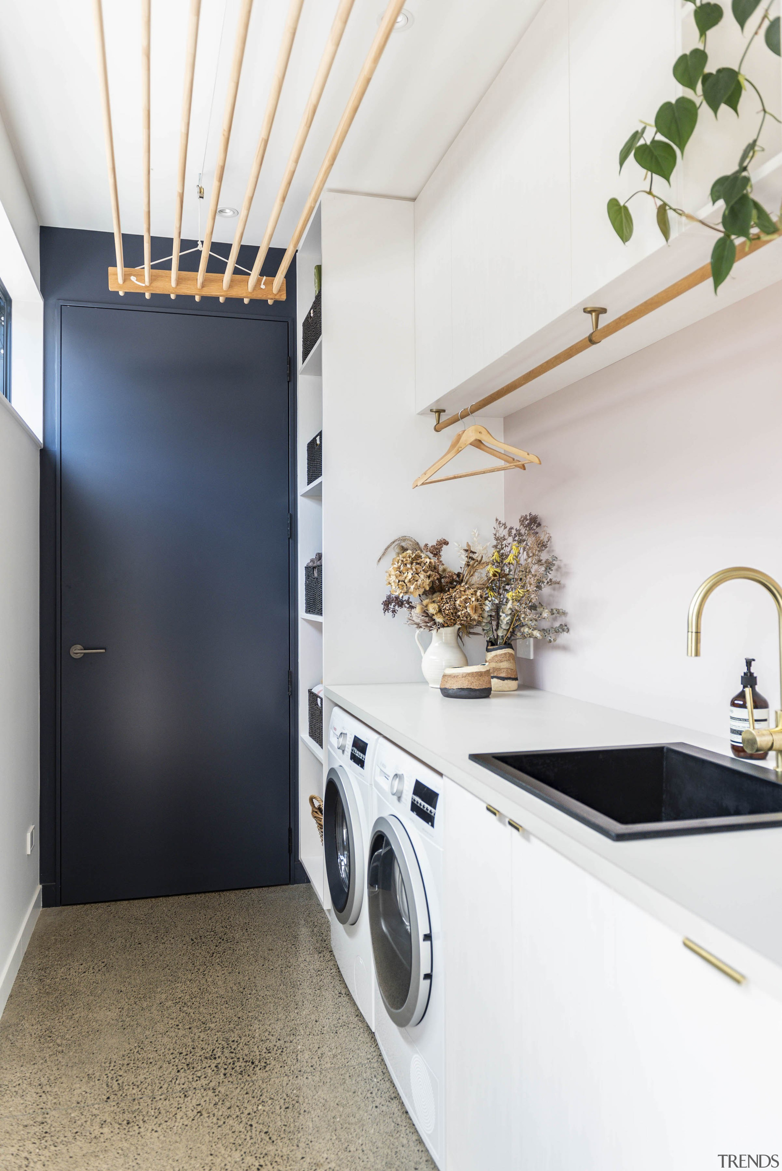 Laundry complete with sustainability-minded ceiling drying rack is 