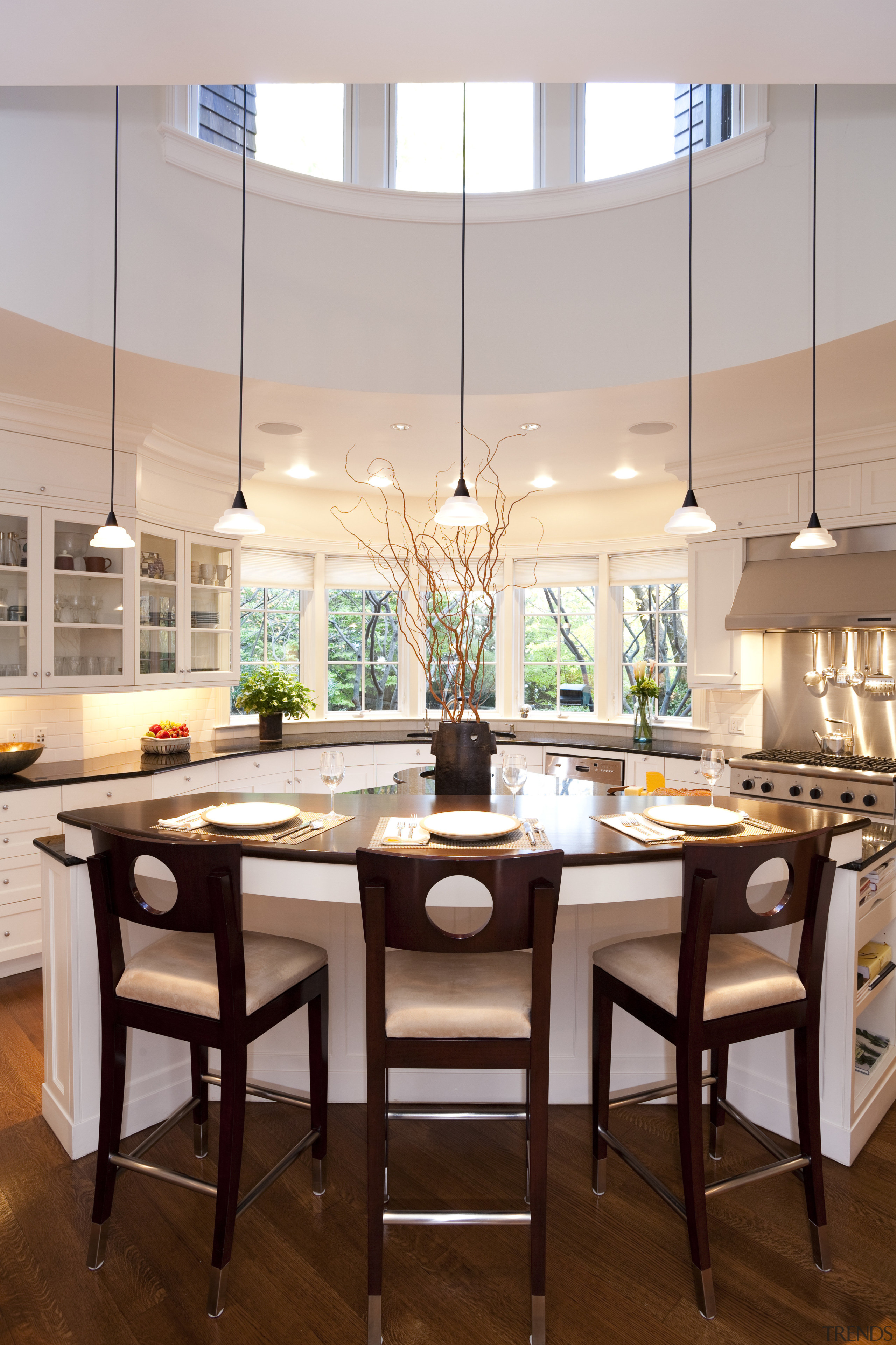 circular kitchen, white cabinets, dark benchtops, wooden floors. ceiling, countertop, dining room, furniture, interior design, kitchen, room, table, gray