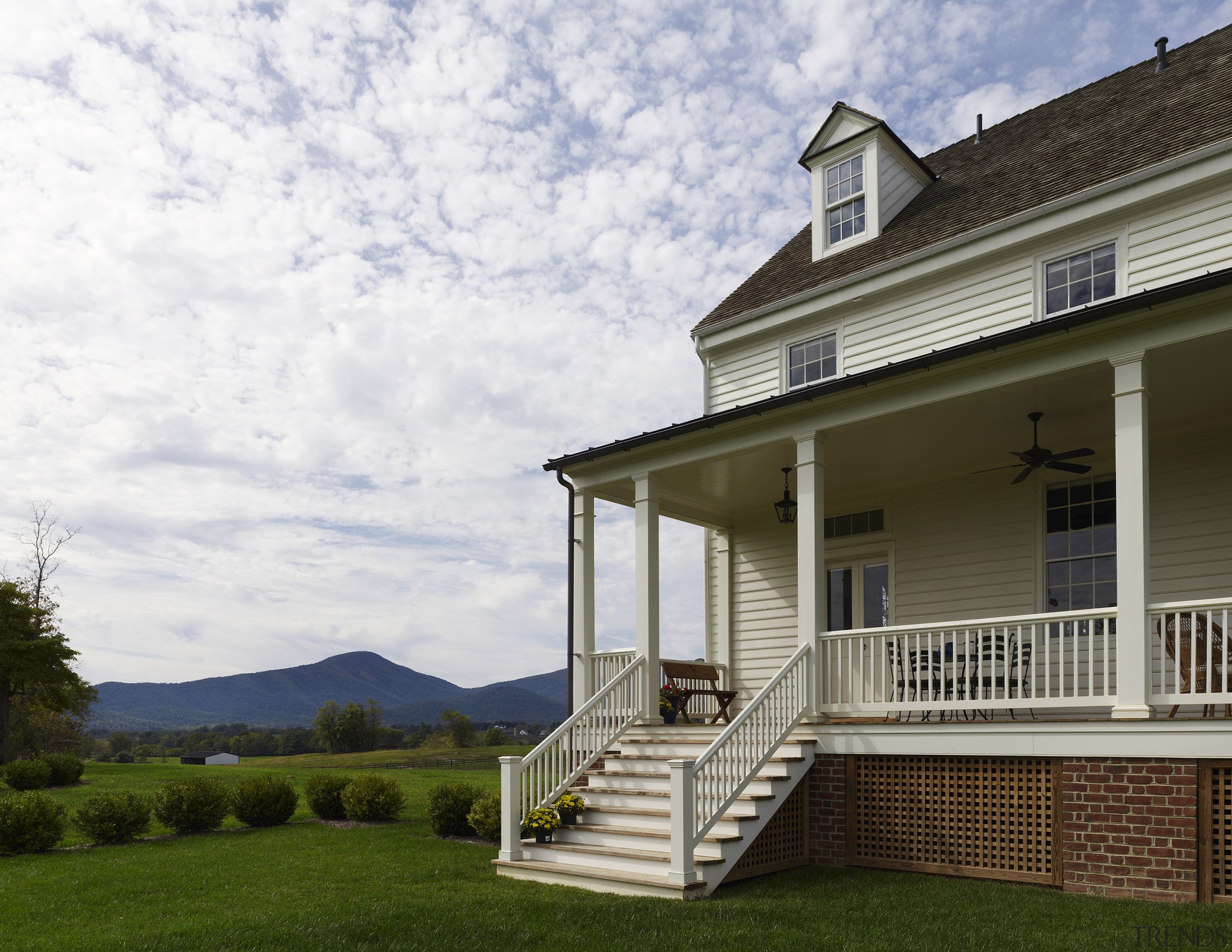 This home was built by Tom Glass of cottage, estate, facade, farmhouse, grass, home, house, outdoor structure, porch, property, real estate, siding, white, brown