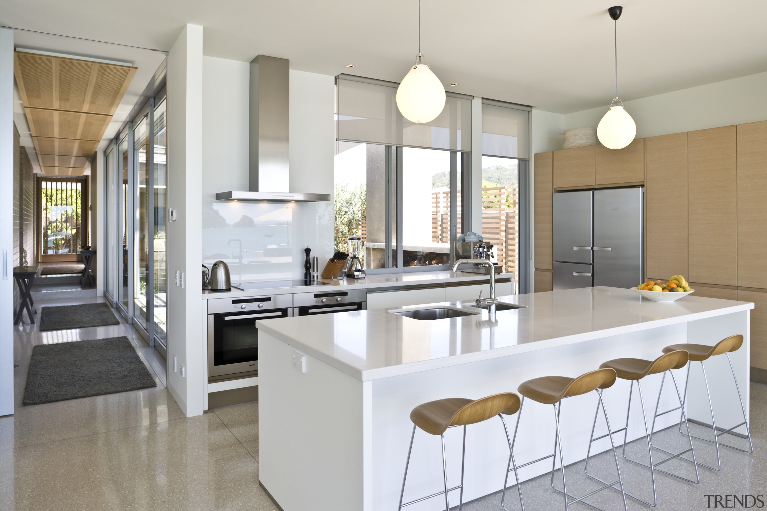 View of kitchen which features kitchen island with countertop, cuisine classique, interior design, kitchen, real estate, gray, white