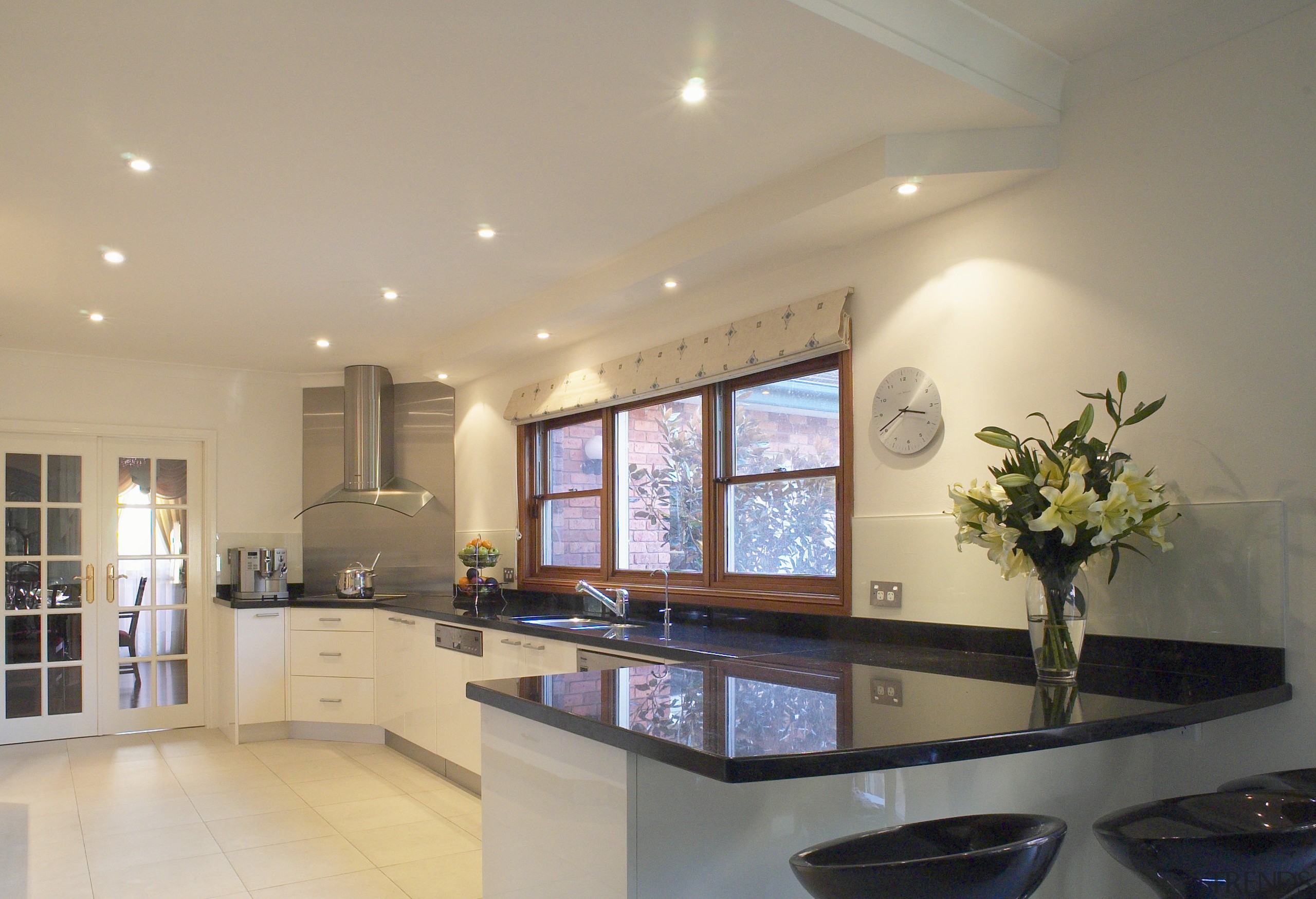 Kitchen with reflective black granite benchtops, light coloured ceiling, countertop, daylighting, interior design, kitchen, property, real estate, room, window, orange
