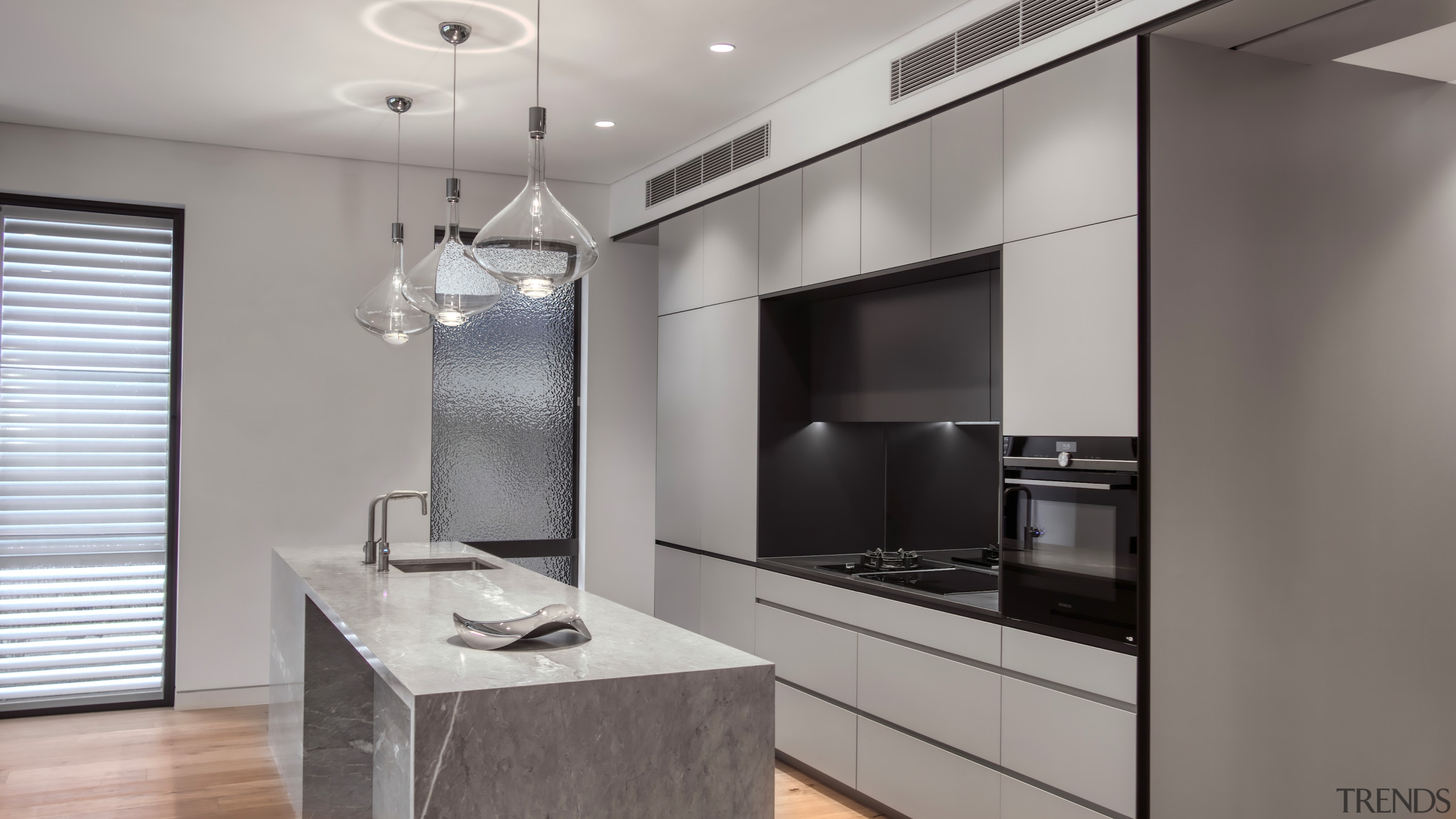 Grey tones play down the contemporary kitchen's presence 