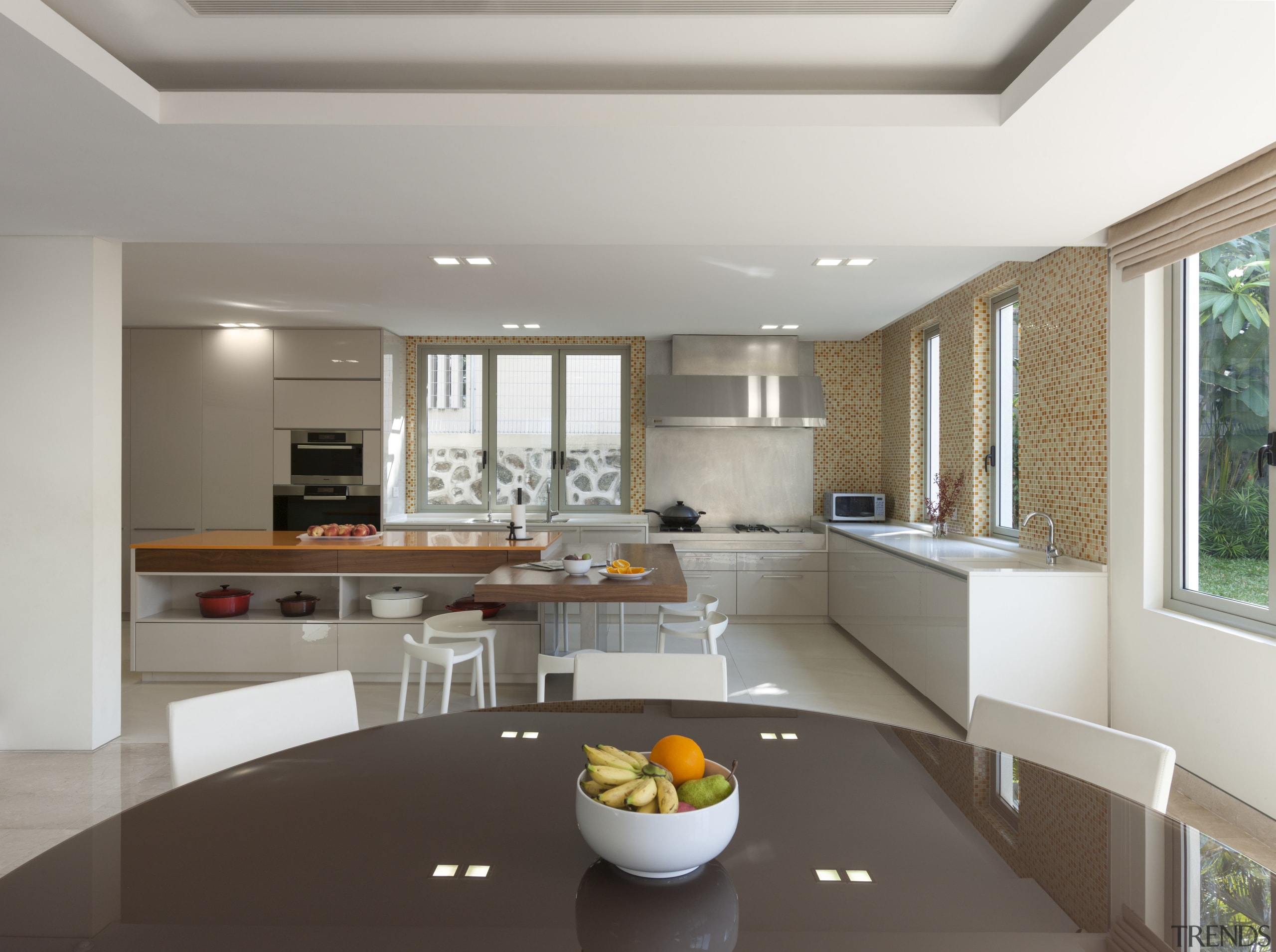 A large L-shaped island is the centrepiece of ceiling, countertop, interior design, kitchen, living room, real estate, gray