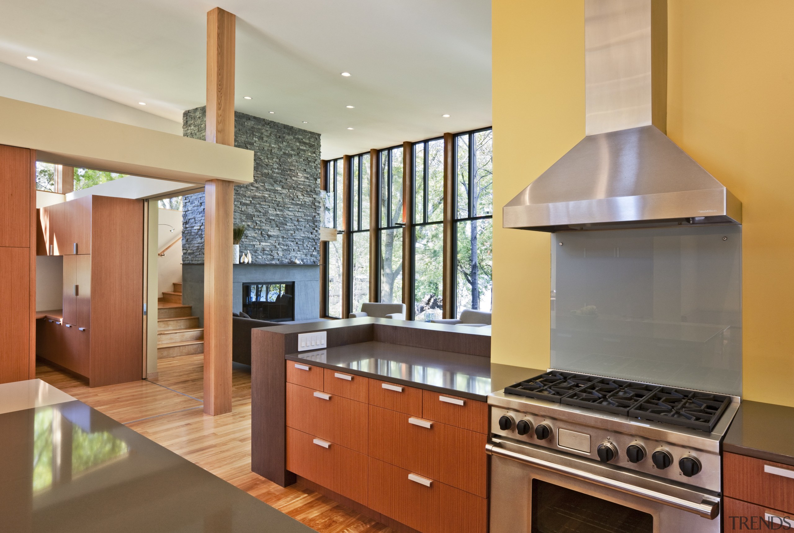 View of the kitchen featuring wenge and mahogany cabinetry, countertop, estate, floor, flooring, hardwood, interior design, kitchen, property, real estate, room, wood flooring, gray, orange