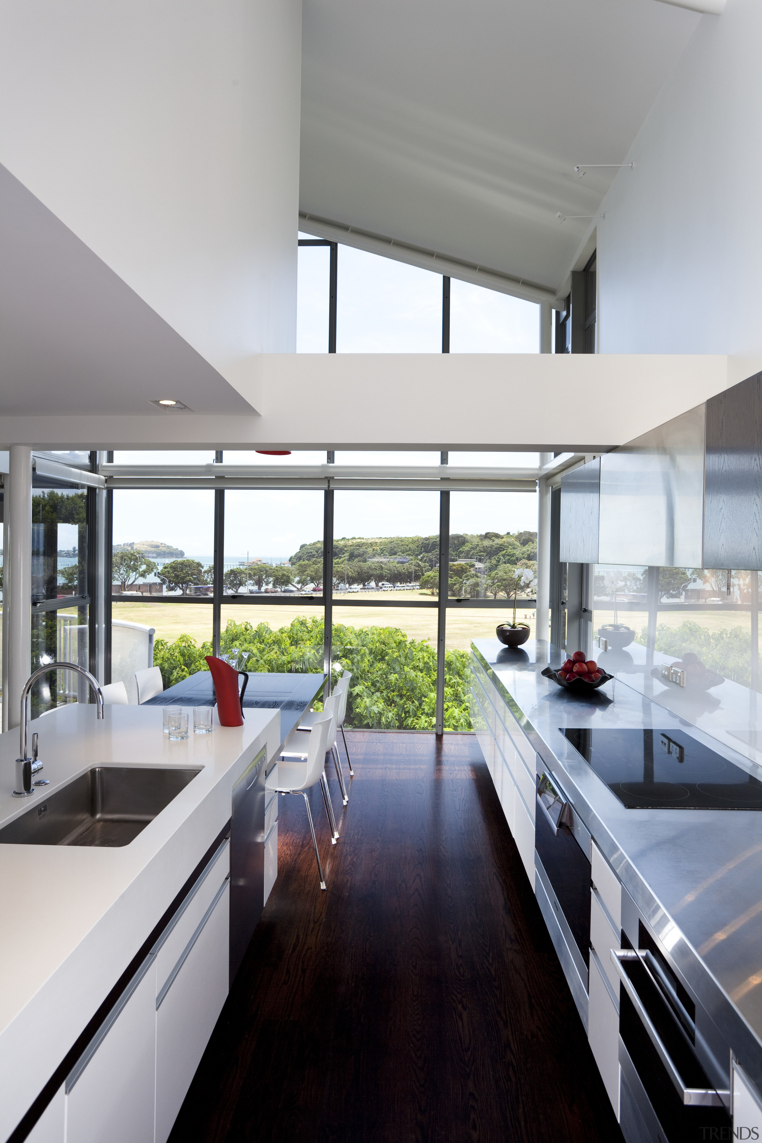 This light-filled galley-style kitchen is orientated to harness architecture, countertop, daylighting, house, interior design, kitchen, real estate, window, gray, white