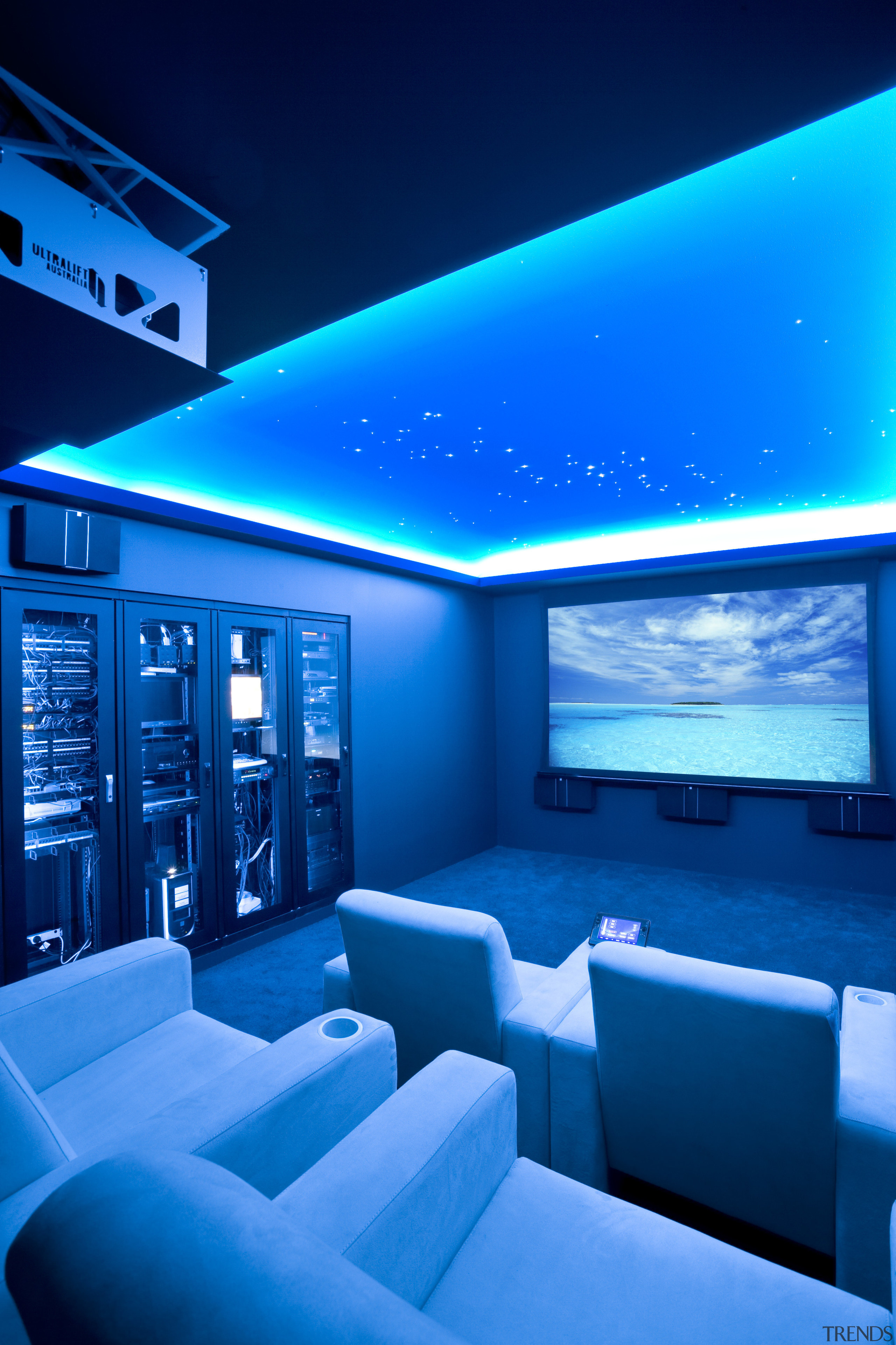 View of home cinema with projector screen, audiovisual architecture, blue, ceiling, display device, interior design, light, lighting, sky, technology, blue, teal