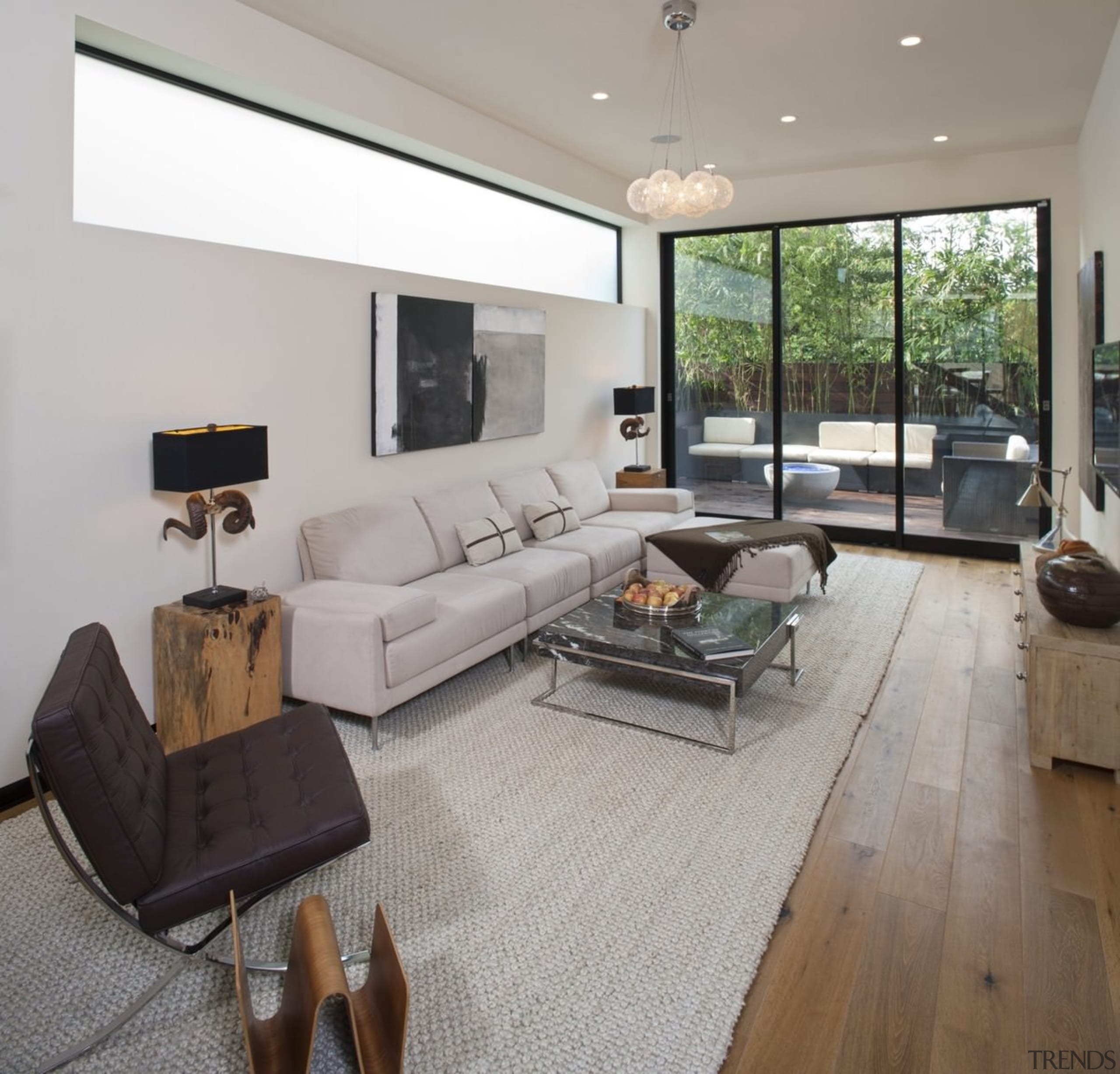 This living space has a green outlook, while ceiling, floor, flooring, hardwood, home, house, interior design, laminate flooring, living room, property, real estate, room, window, wood flooring, gray