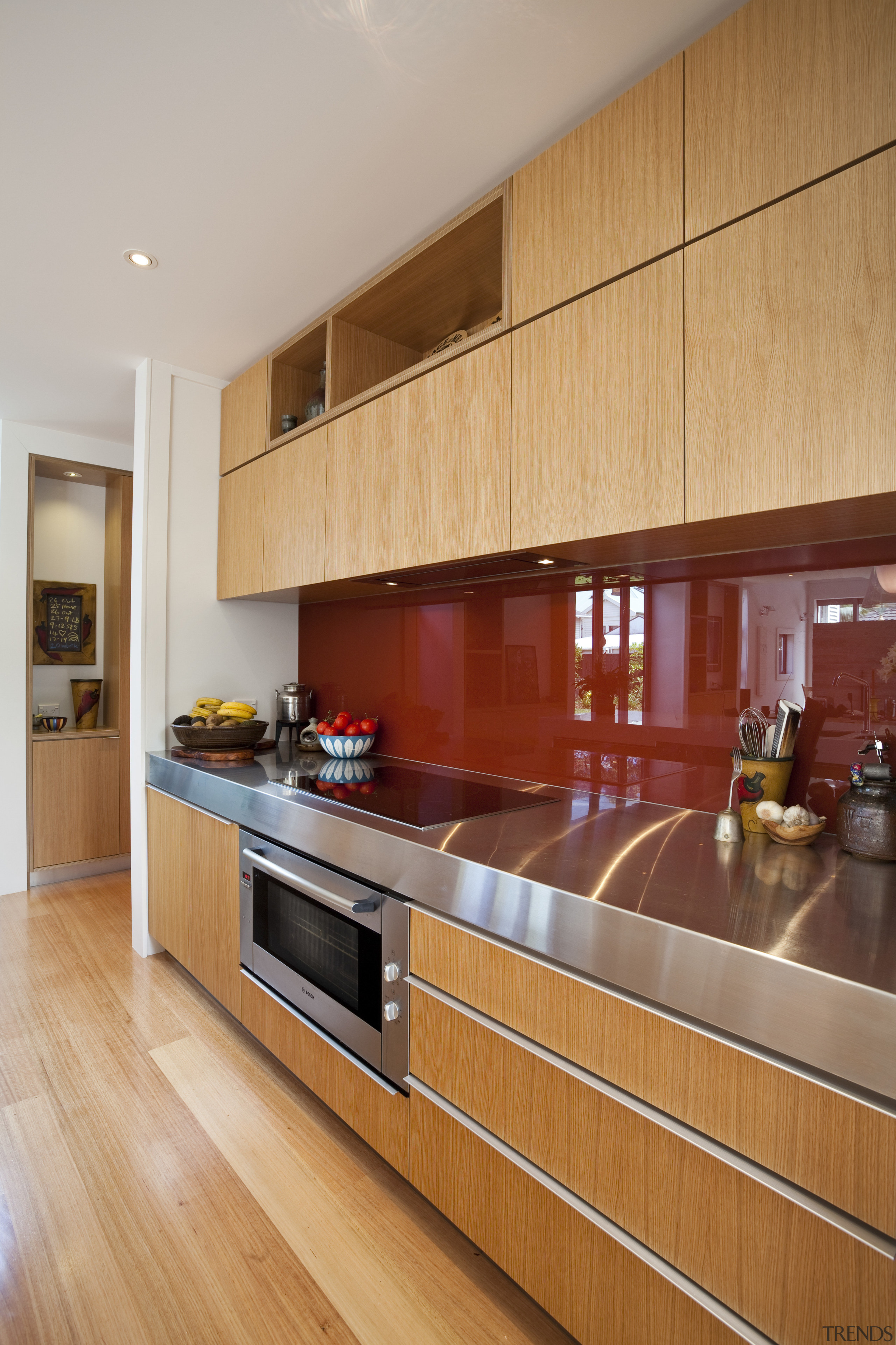 View of kitchen with stainless bench, wooden cabinetry cabinetry, countertop, cuisine classique, floor, flooring, hardwood, interior design, kitchen, laminate flooring, room, under cabinet lighting, wood, wood flooring, orange, gray