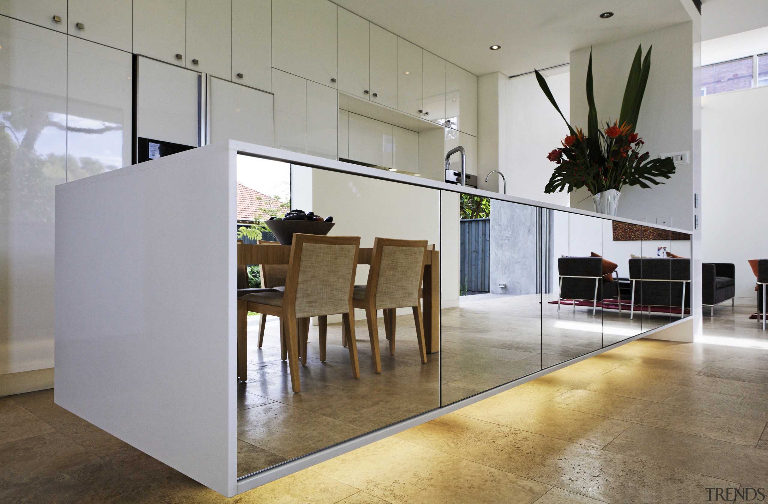 View of kitchen area with lacquered cabinetry, appliances. floor, flooring, interior design, lobby, loft, table, wood flooring, gray