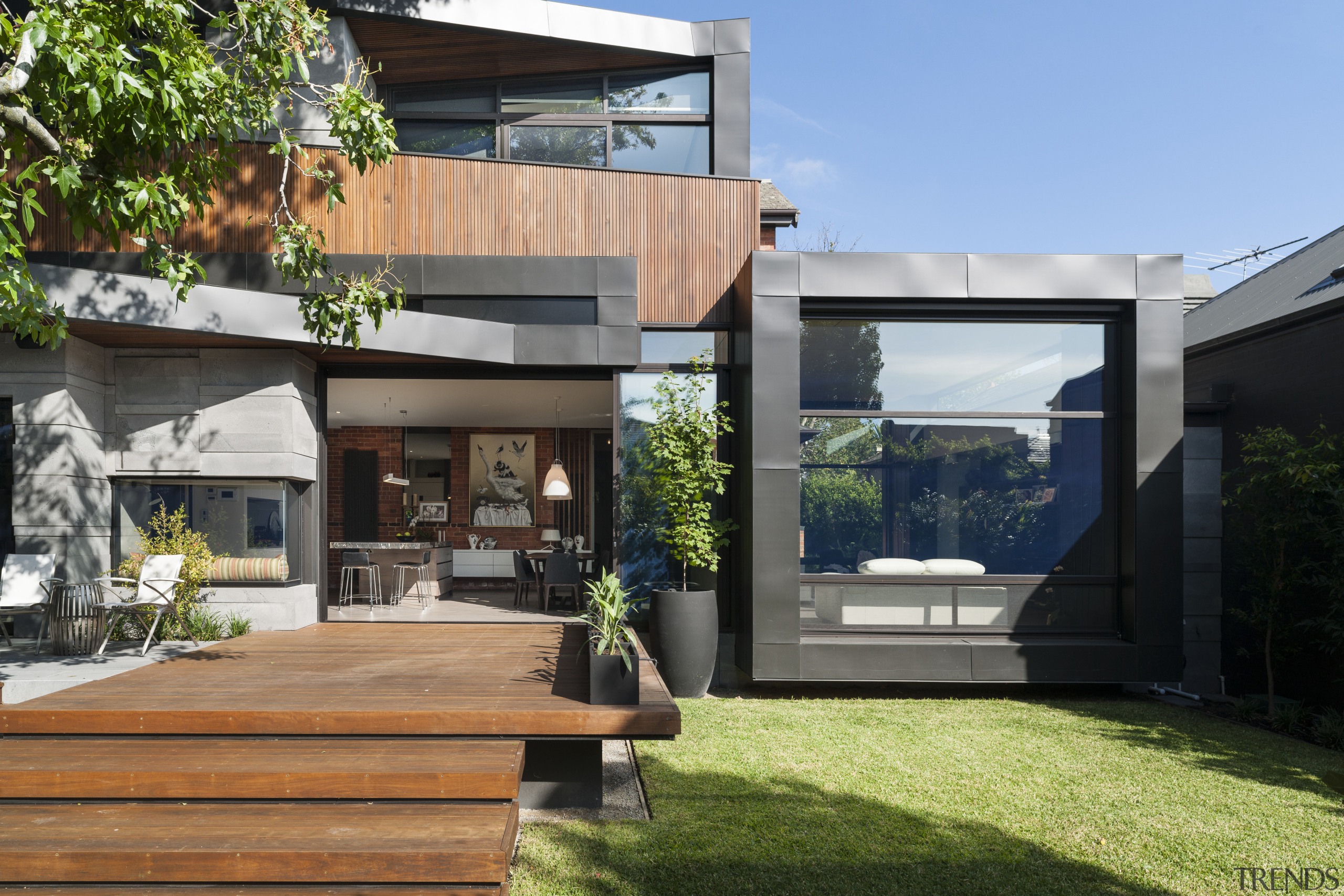 The rear of this renovated home is a architecture, backyard, courtyard, estate, facade, home, house, property, real estate, residential area, yard, black