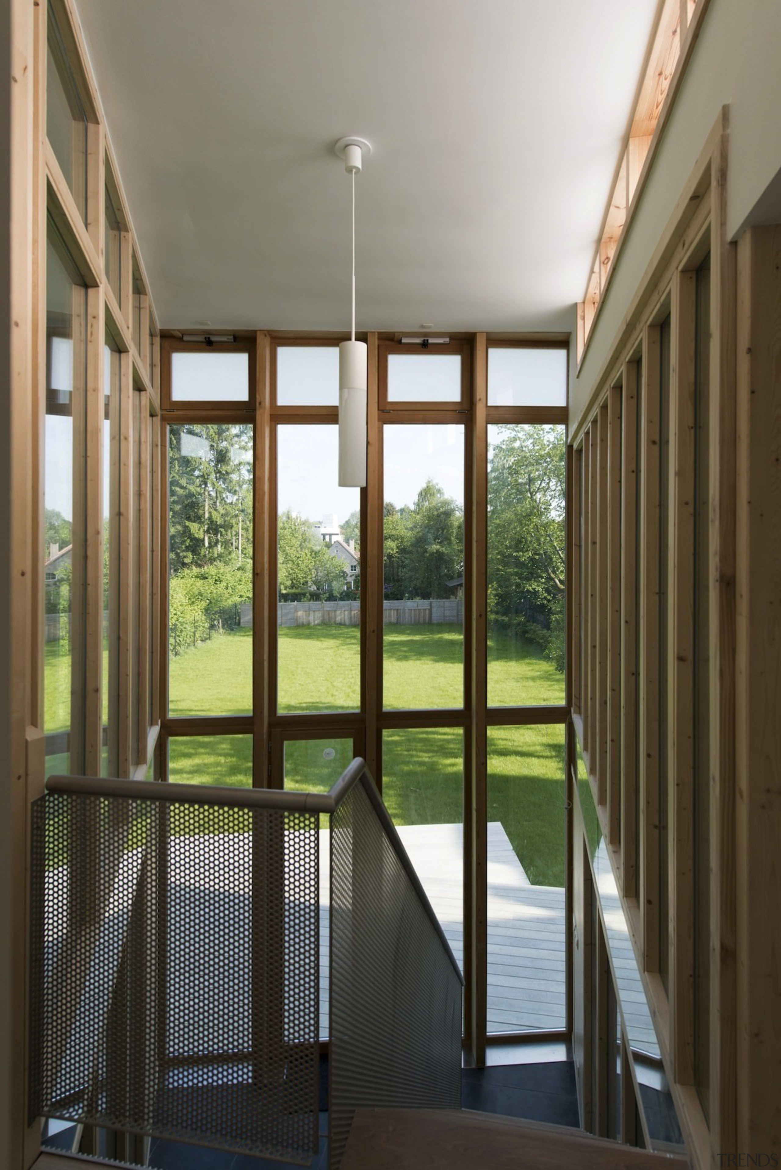 A large hanging cylindrical light illuminates the entranceway architecture, daylighting, door, estate, home, house, interior design, porch, real estate, window, brown, gray