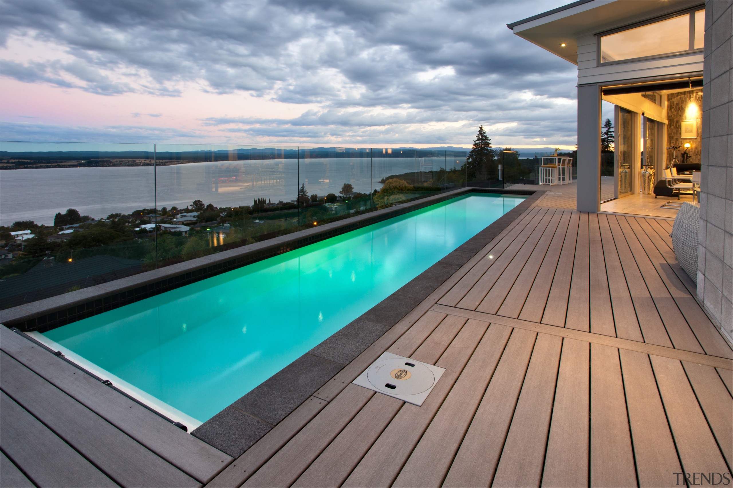 This modern lap pool forms the centrepiece of deck, estate, leisure, property, real estate, roof, sky, swimming pool, water, gray