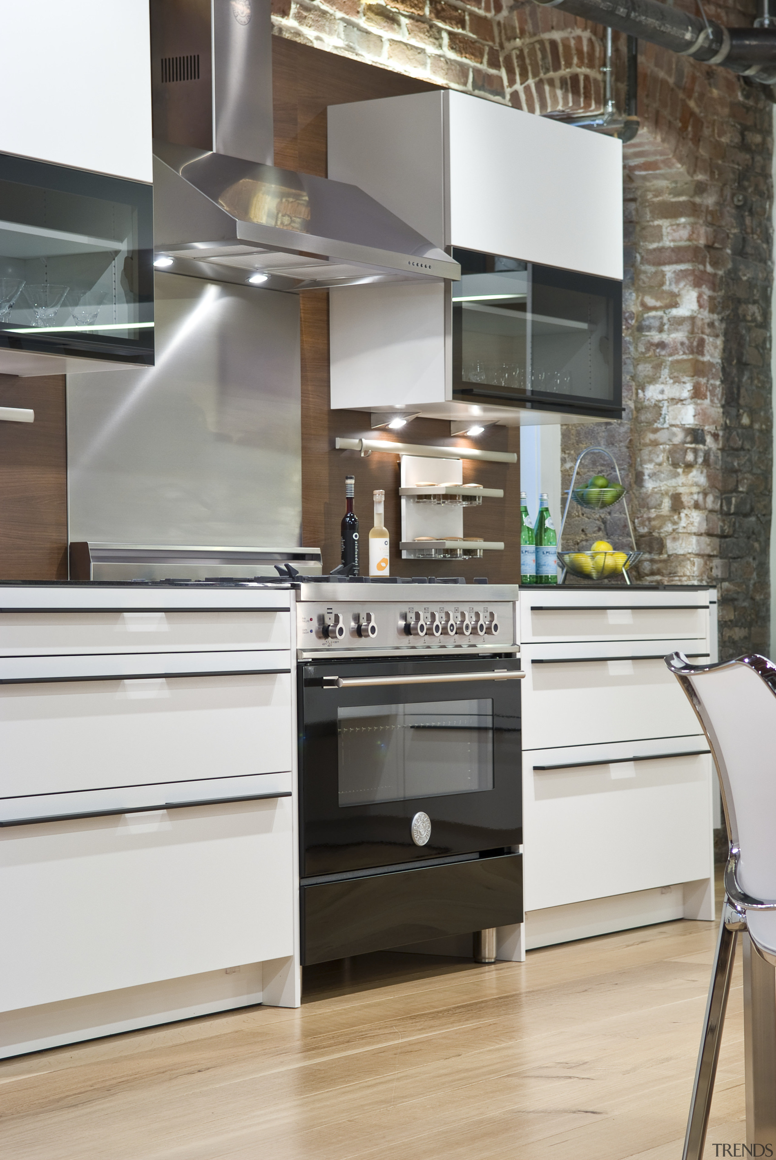 View of a contemporary kitchen which features a cabinetry, countertop, cuisine classique, floor, furniture, home appliance, interior design, kitchen, gray