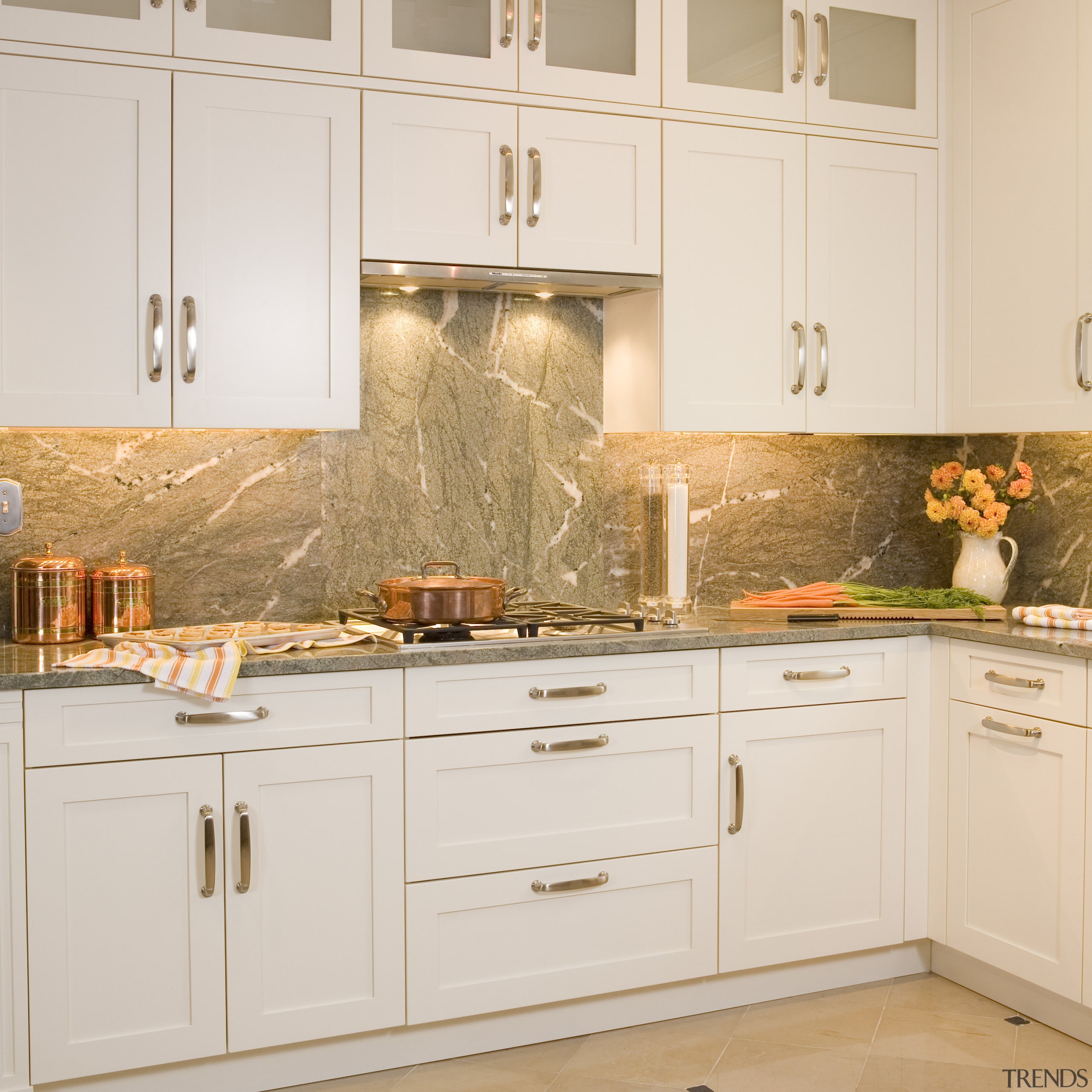 Image of a showroom kitchen at the A&amp;D cabinetry, countertop, cuisine classique, floor, flooring, furniture, home, interior design, kitchen, room, tile, under cabinet lighting, wall, white