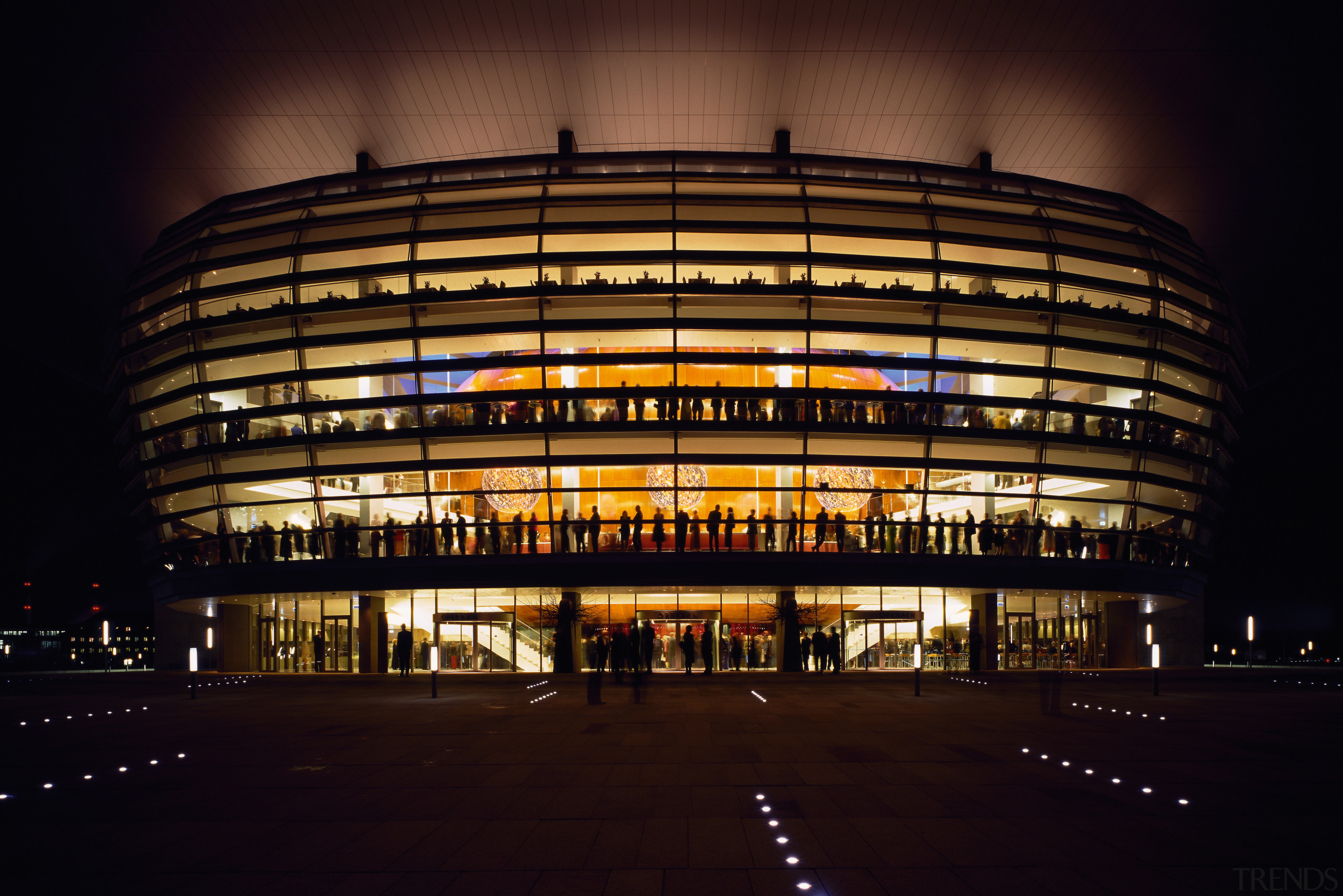 An exterior view of the building. - An architecture, building, city, corporate headquarters, darkness, evening, facade, landmark, light, lighting, metropolis, metropolitan area, night, reflection, sky, sport venue, stadium, structure, urban area, black, brown