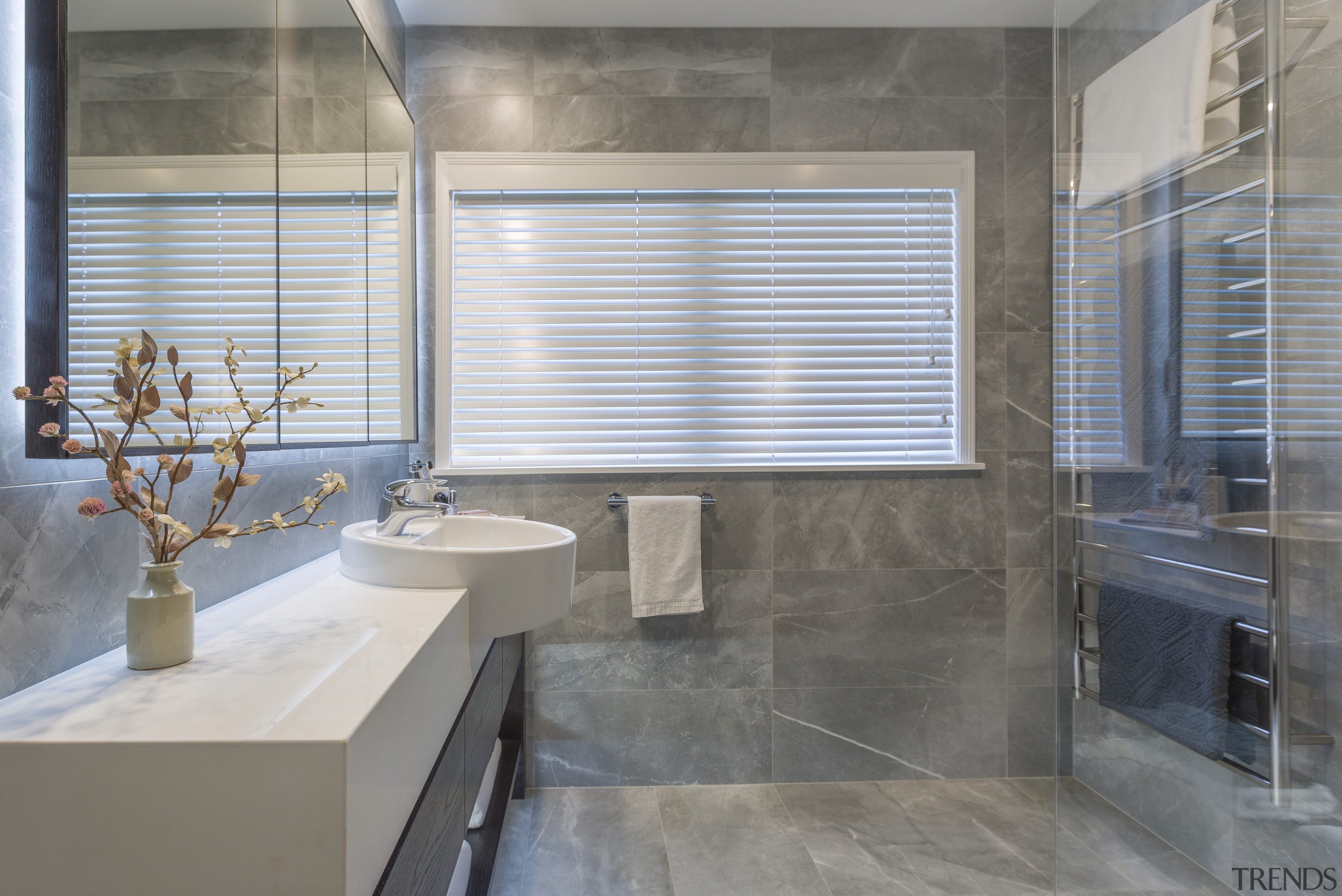 Introducing a large heated towel rack to this architecture, bathroom, building, ceramic, floor, flooring, glass, interior design, marble, material property, plumbing fixture, property, real estate, room, tile, window covering, gray