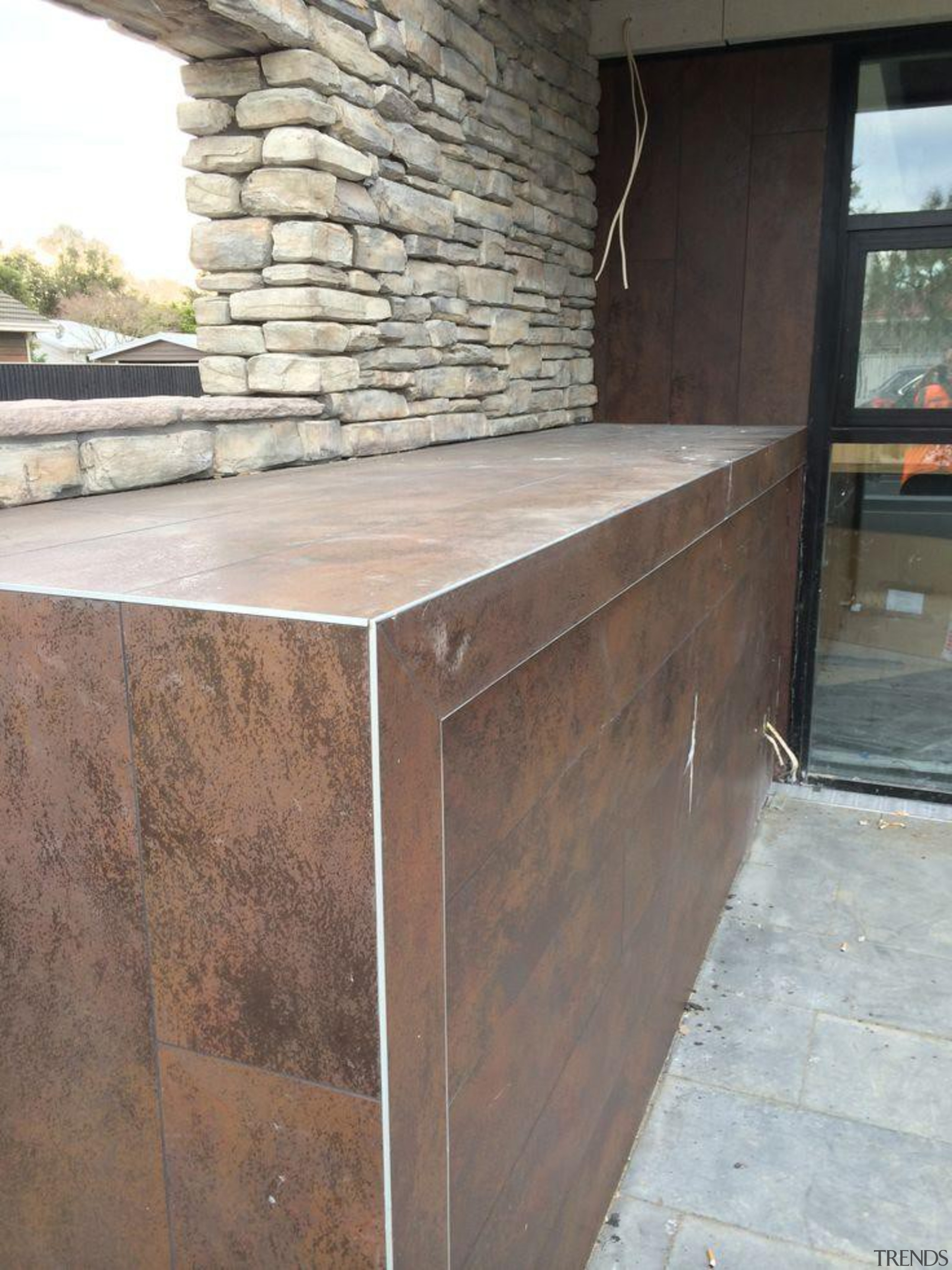 Exterior detail featuring Oxide Moro. - Creyke House furniture, wall, wood stain, gray, brown