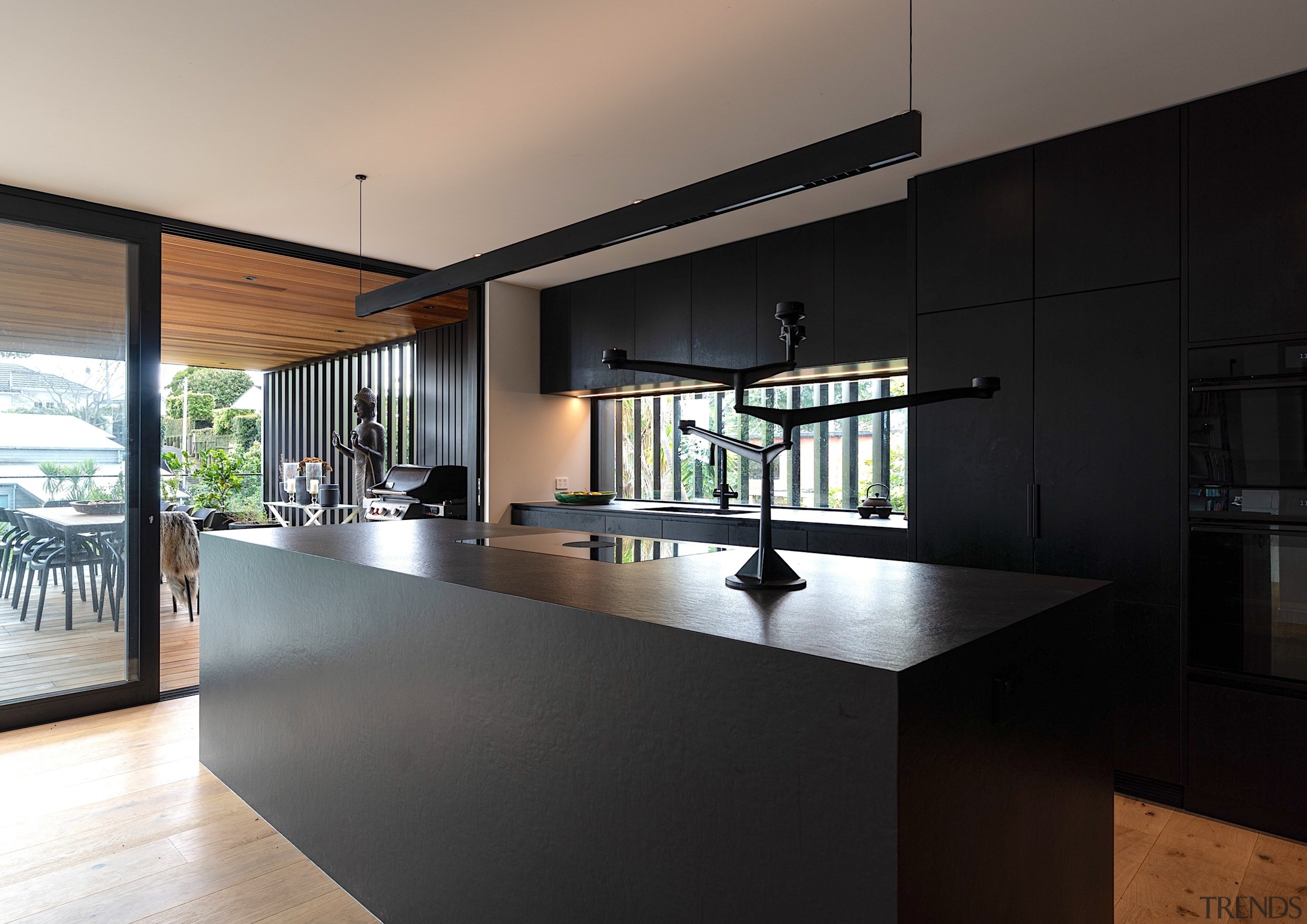 Contemporary family kitchen complete with dramatic monolithic black 