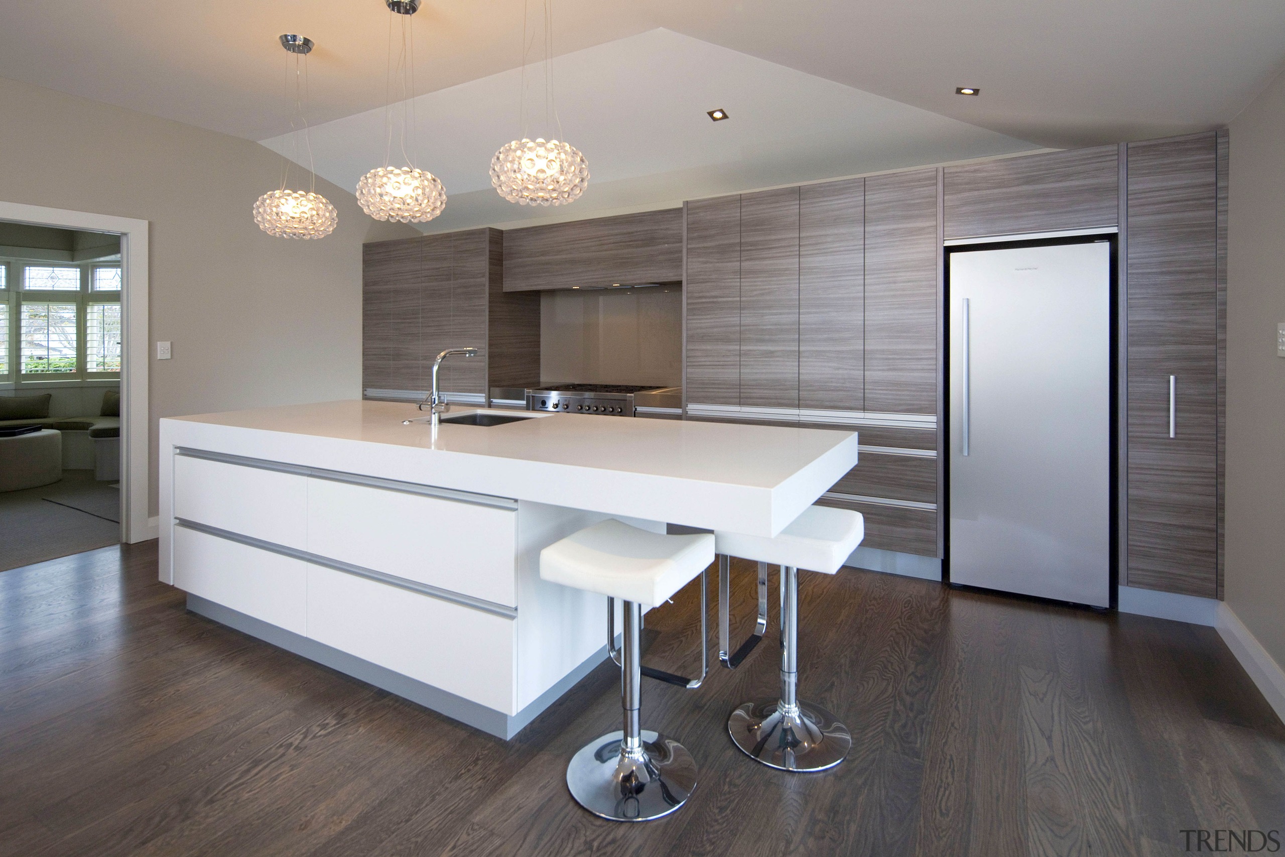 View of a kitchen which features white CeasarStone architecture, cabinetry, countertop, floor, flooring, hardwood, interior design, kitchen, laminate flooring, real estate, room, wall, window, wood, wood flooring, gray