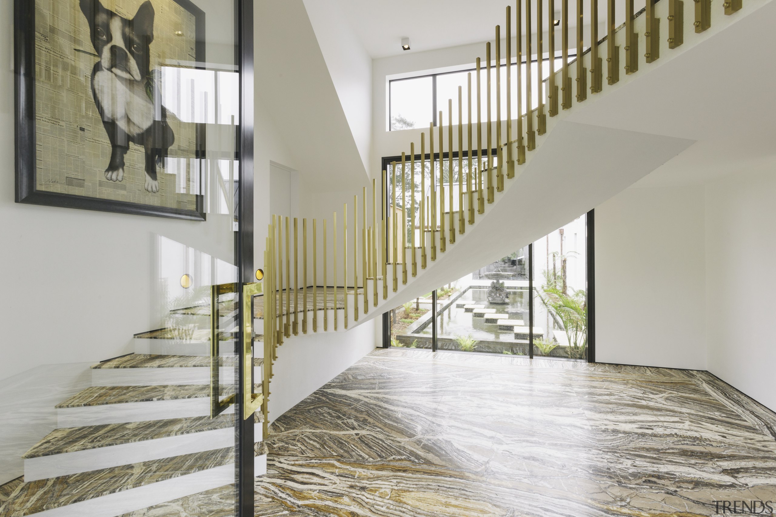 A dramatic stair leads up to the private daylighting, estate, floor, flooring, handrail, hardwood, home, house, interior design, laminate flooring, property, real estate, stairs, wood, wood flooring, gray