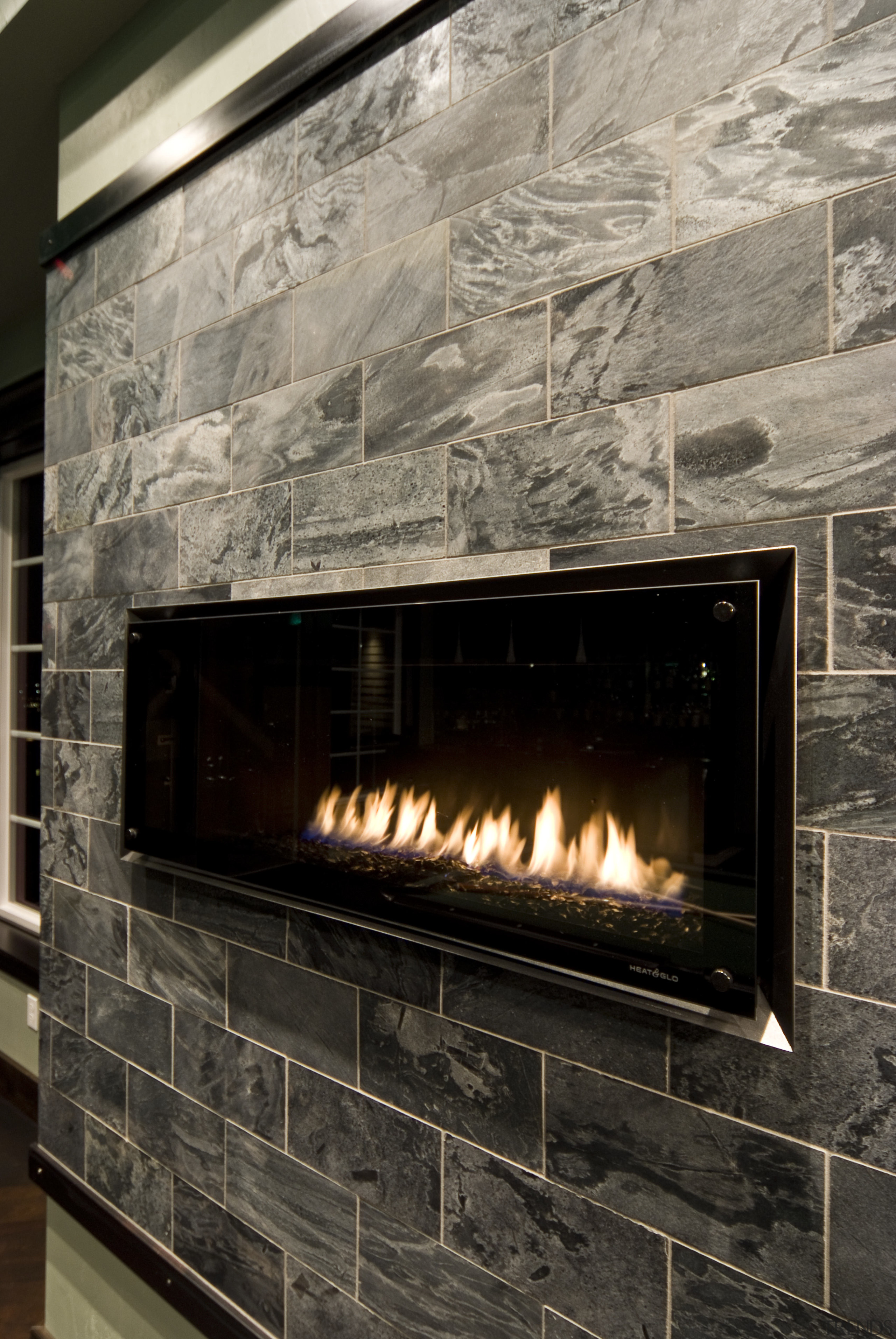 Director Dan Cooper of DC Fine Homes and fireplace, hearth, heat, black, gray