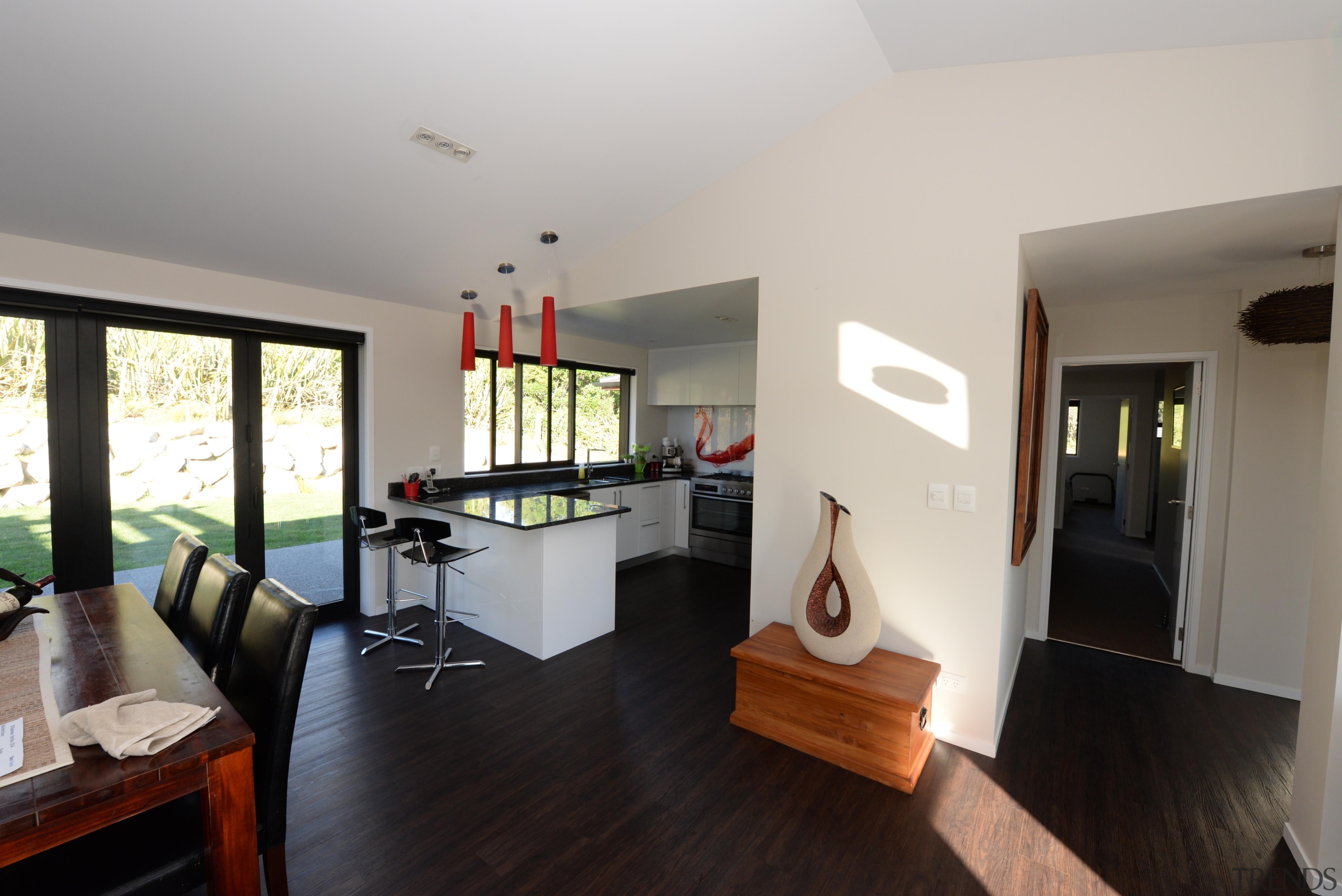 This home is built by Fowler Homes Taranaki floor, flooring, house, interior design, living room, property, real estate, room, gray, black