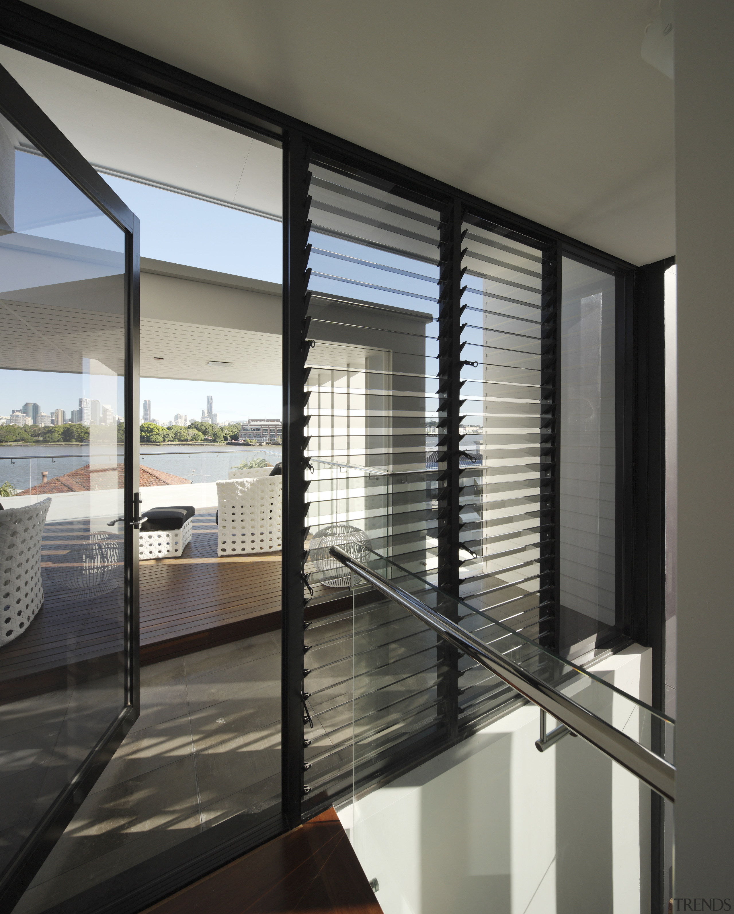 An internal staircase leads to the roof deck architecture, condominium, daylighting, door, glass, house, interior design, real estate, window, window blind, window covering, window treatment, gray, black