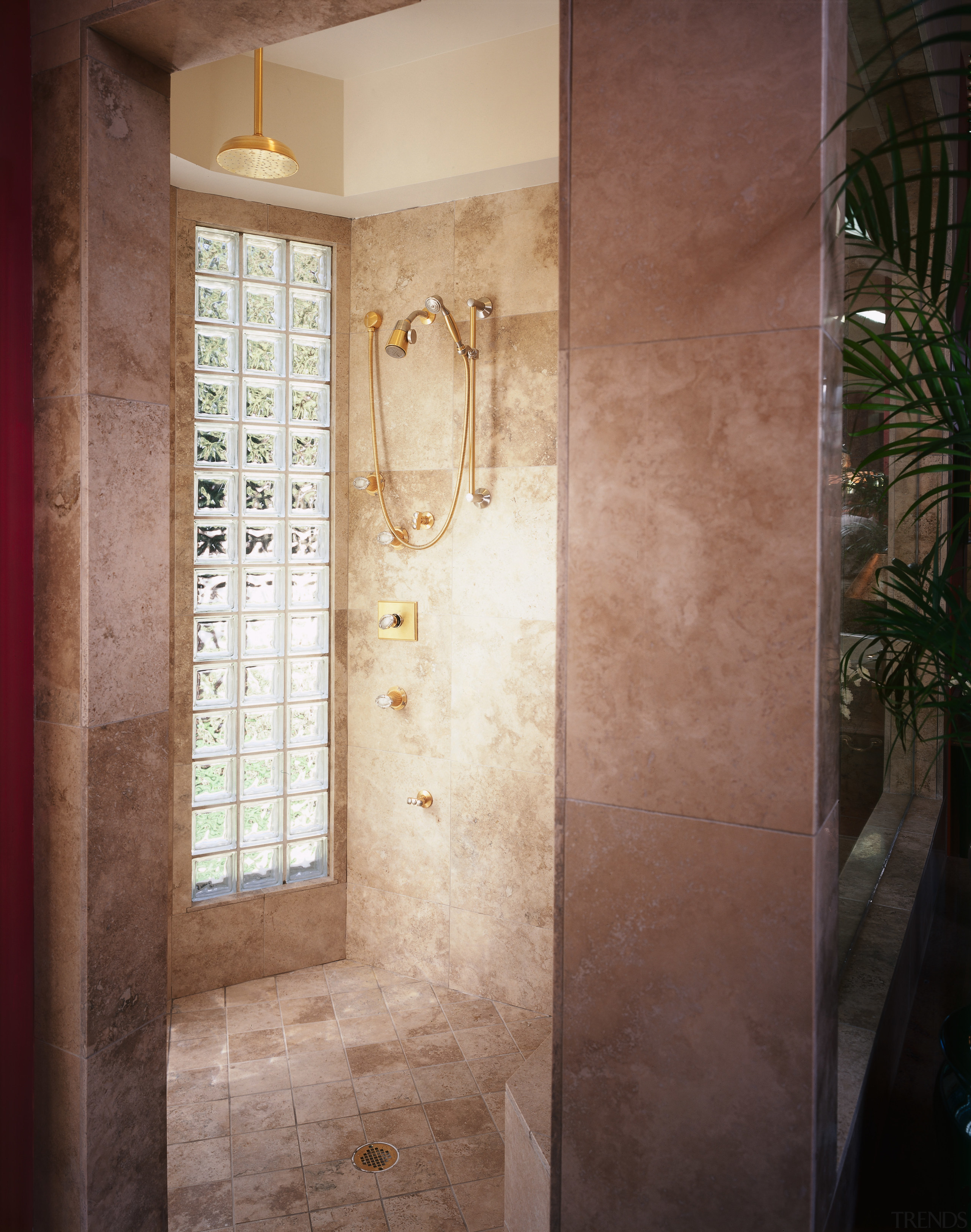 A view of the shower stall. - A bathroom, door, floor, flooring, home, interior design, plaster, plumbing fixture, room, tile, wall, window, brown