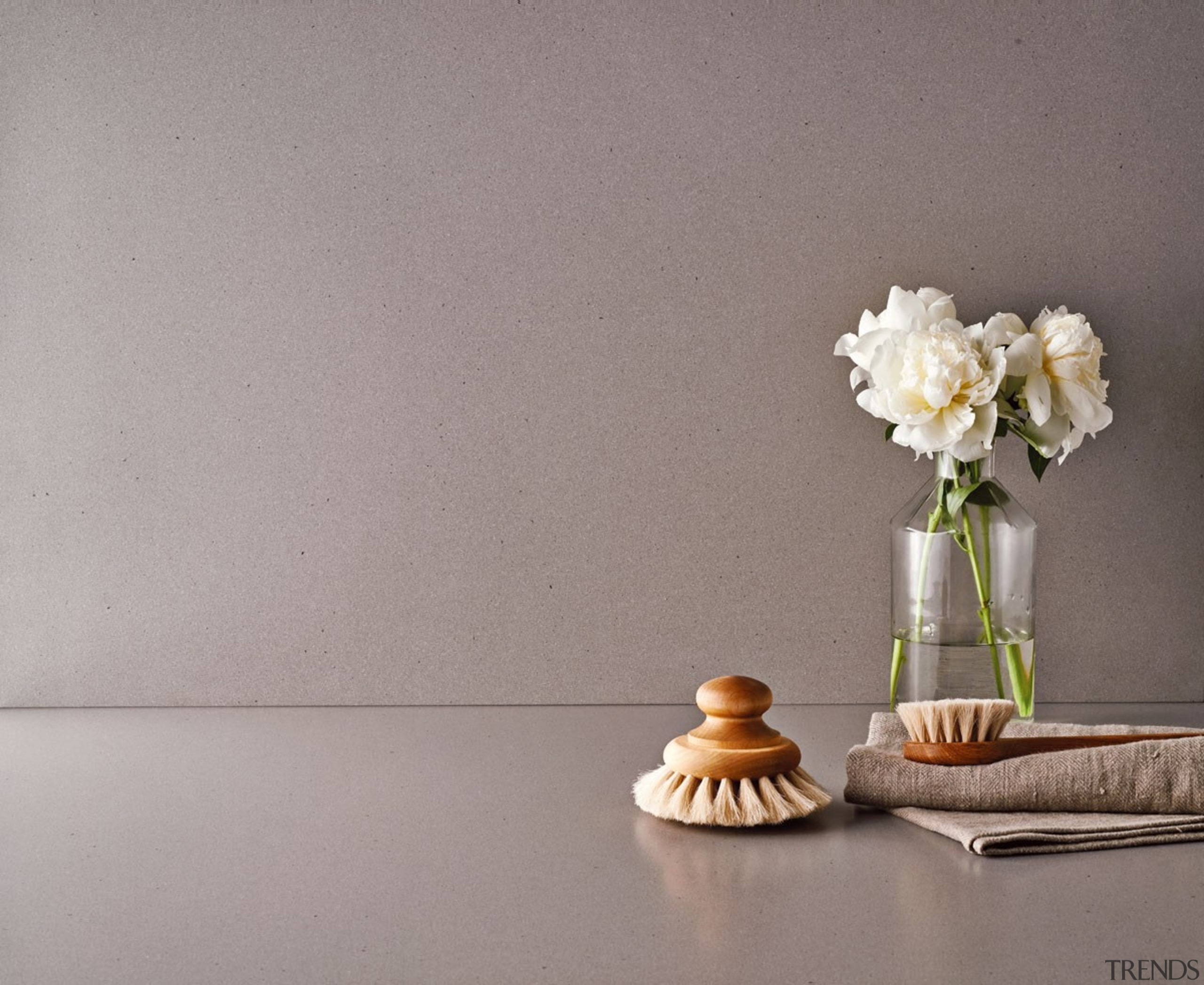 A warm grey with a distinctive texture delivering product design, still life, still life photography, table, vase, gray