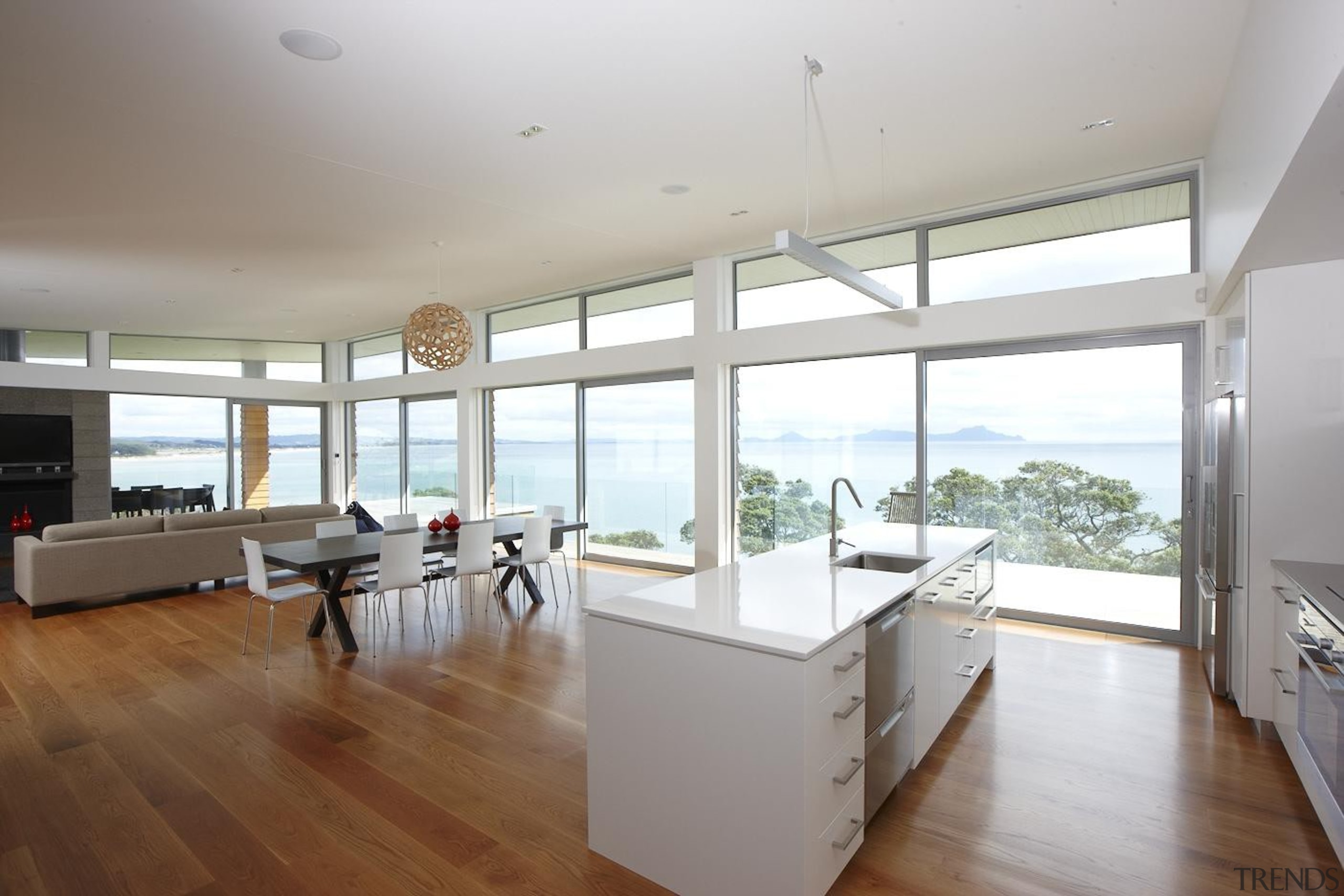 Open plan living in an amazing seaside setting. architecture, daylighting, floor, flooring, hardwood, house, interior design, kitchen, property, real estate, window, wood flooring, gray