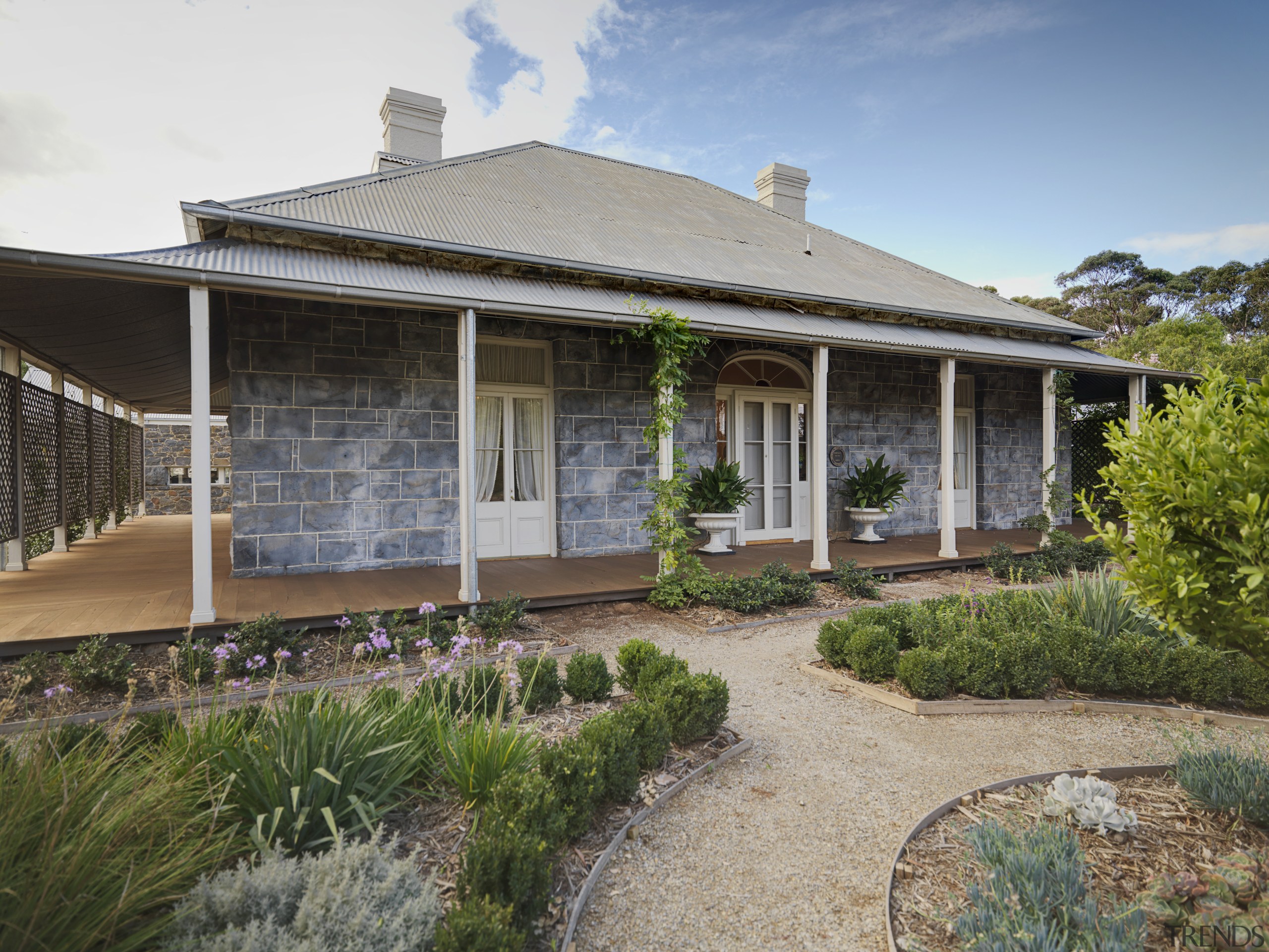 The restored jarrah verandah and bluestone walls replicate backyard, cottage, estate, facade, farmhouse, home, house, outdoor structure, property, real estate, villa, yard, gray