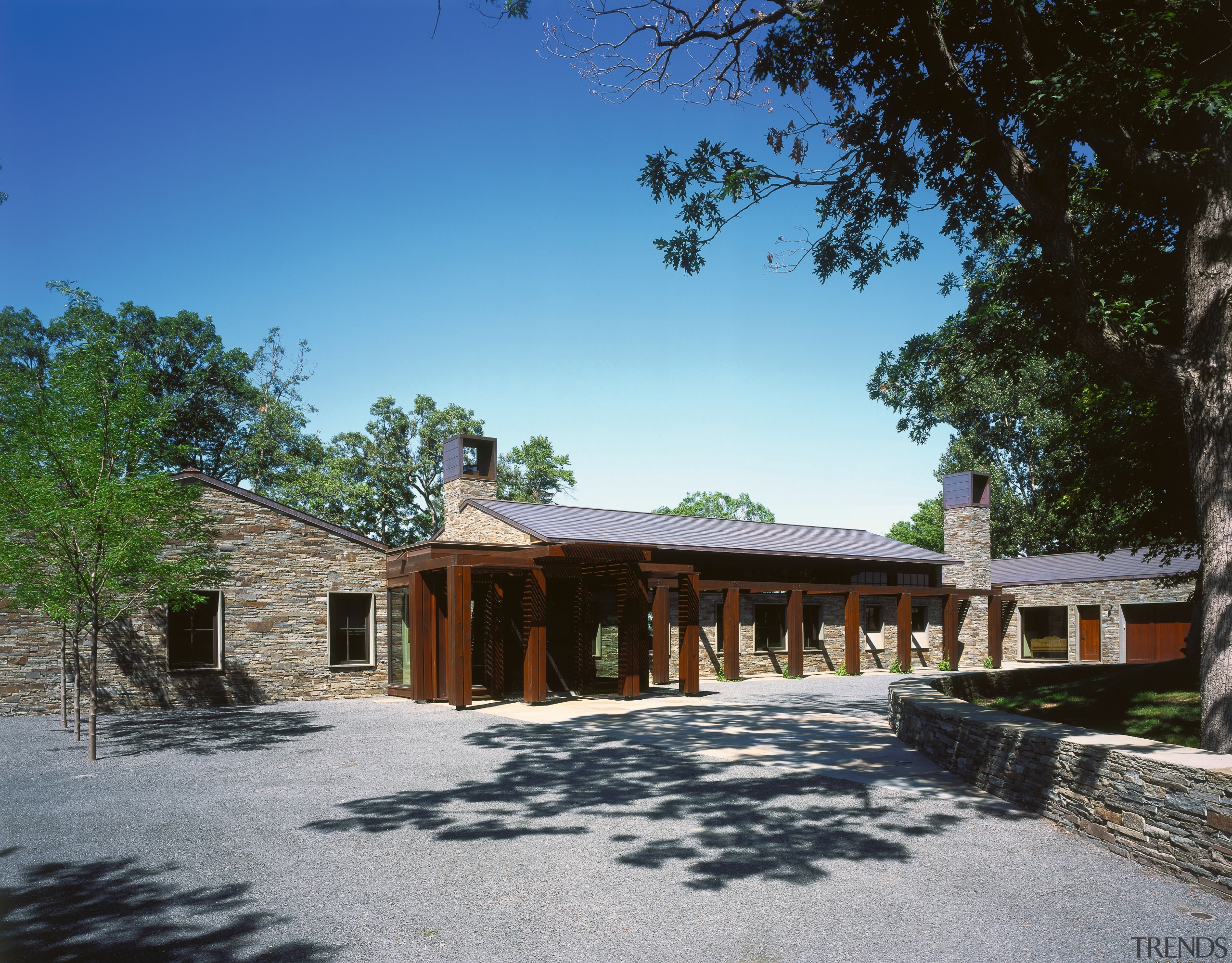 Image of the exterior of this beautiful lakeside cottage, estate, hacienda, home, house, landscape, property, real estate, sky, tree, villa, black