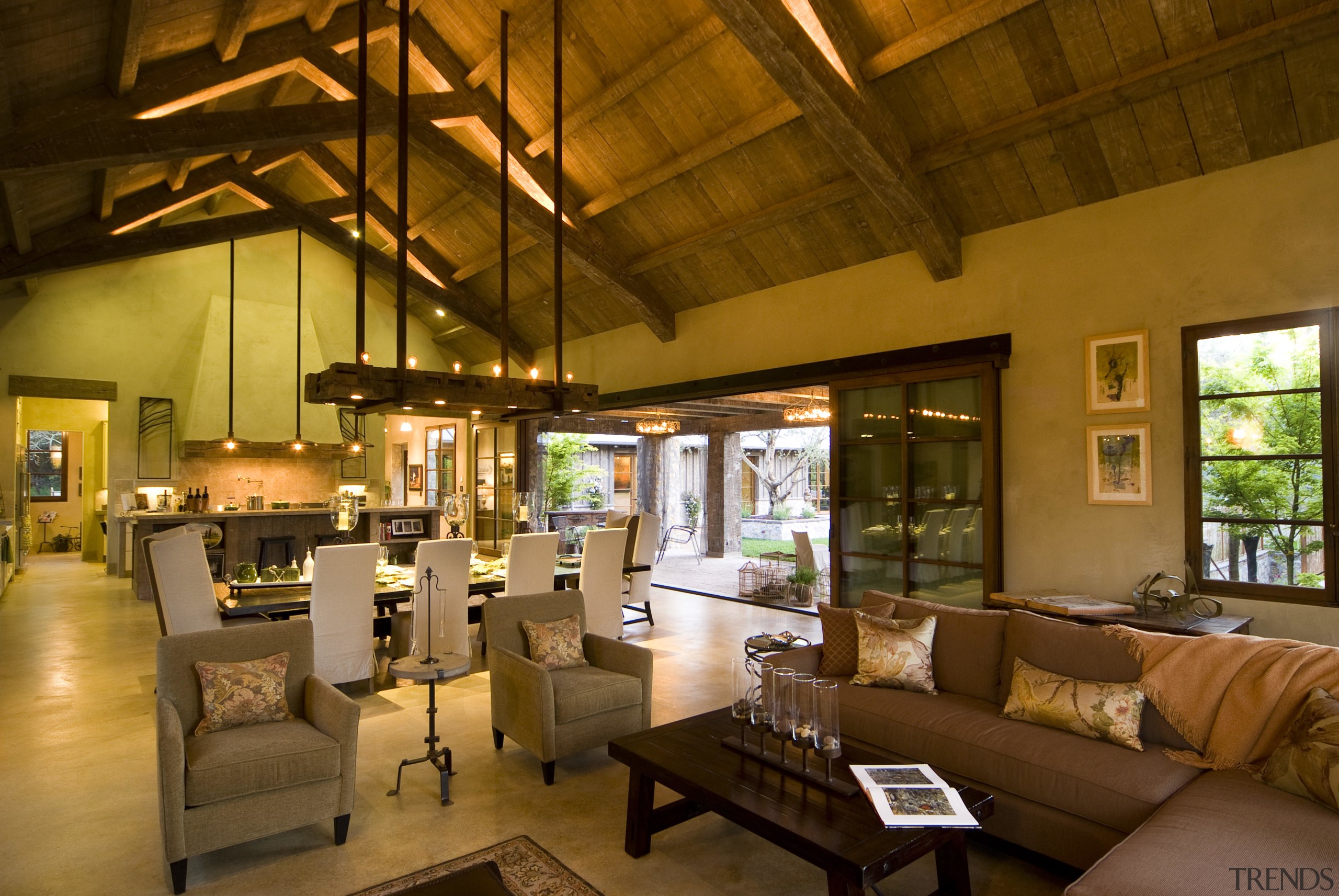 Rustic house modelled on French barn. Interiors feature interior design, living room, lobby, real estate, brown