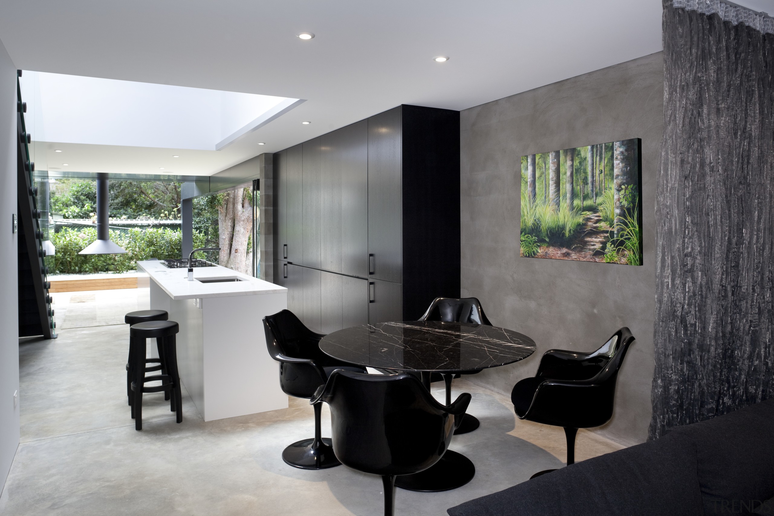 Dining room, lkitchen, stairway. White island, black cabinetry. architecture, floor, flooring, house, interior design, living room, real estate, gray, black