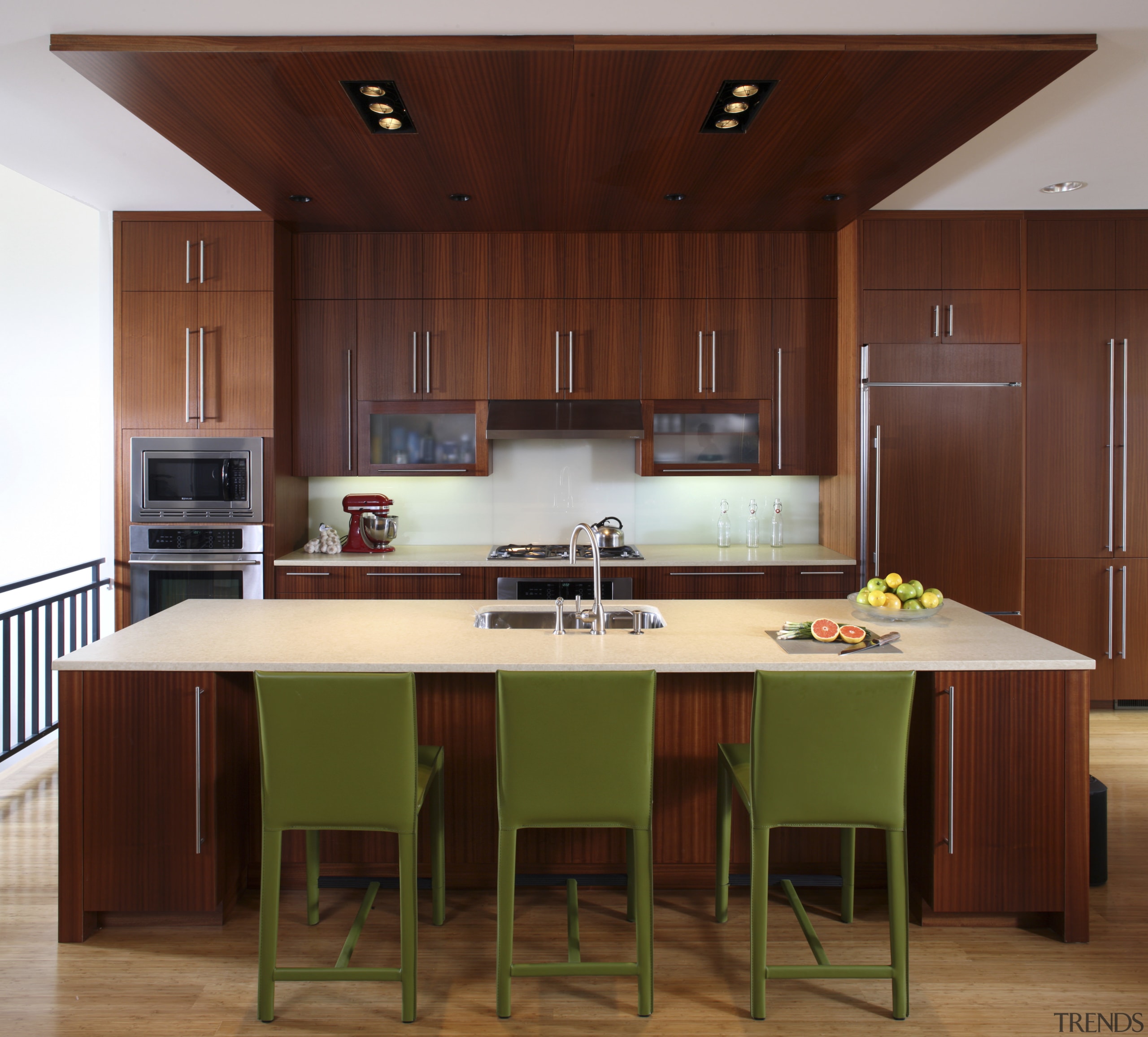 View of a kitchen which features a kitchen cabinetry, countertop, cuisine classique, hardwood, interior design, kitchen, room, table, wood, red, brown