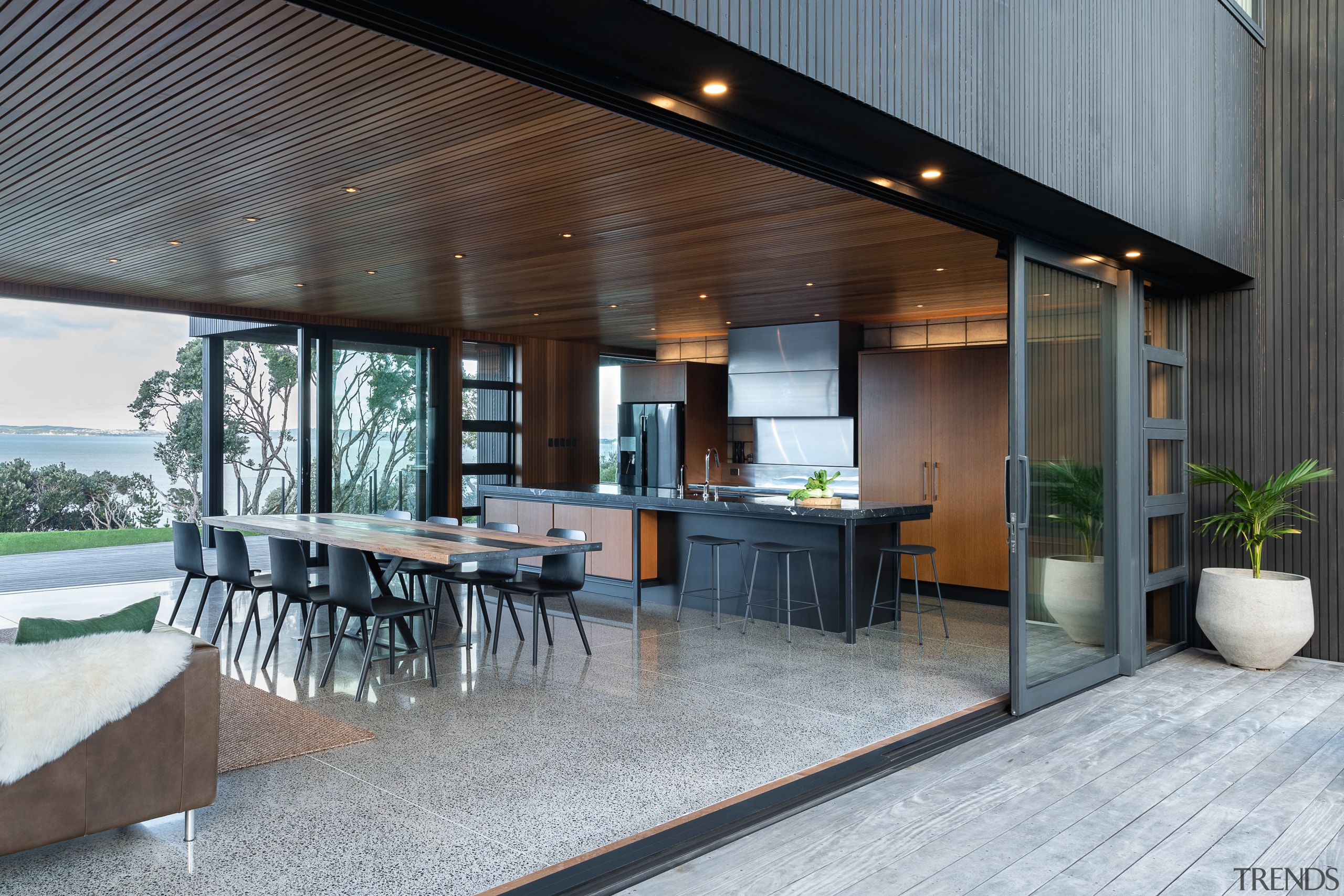 ​​​​​​​Context is everything. This kitchen connects with and architecture, backyard, building, ceiling, deck, design, estate, floor, flooring, furniture, home, house, interior design, landscaping, patio, porch, property, real estate, roof, room, table, gray, black