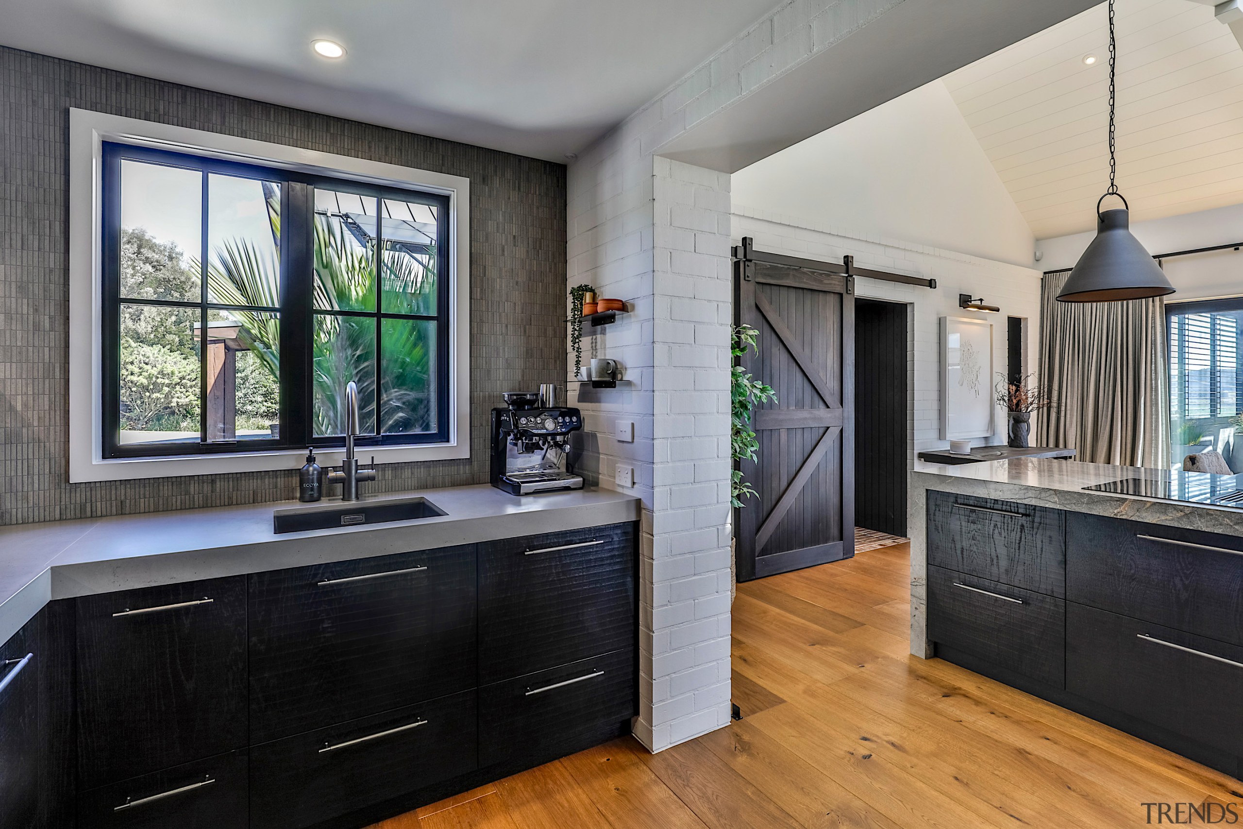 The scullery-kitchen barn door divider has its precedent 