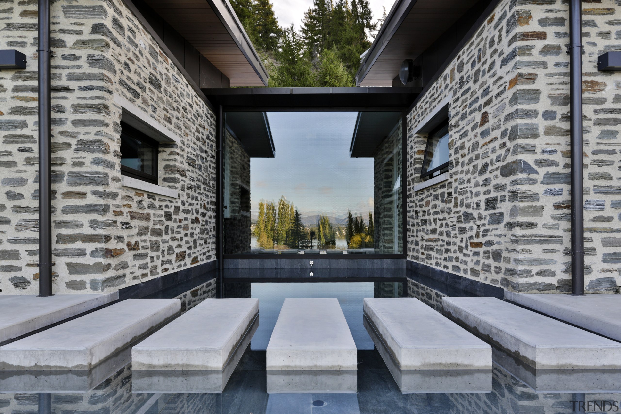 During the warmer months, stepping stones over this architecture, building, estate, home, property, real estate, swimming pool, gray