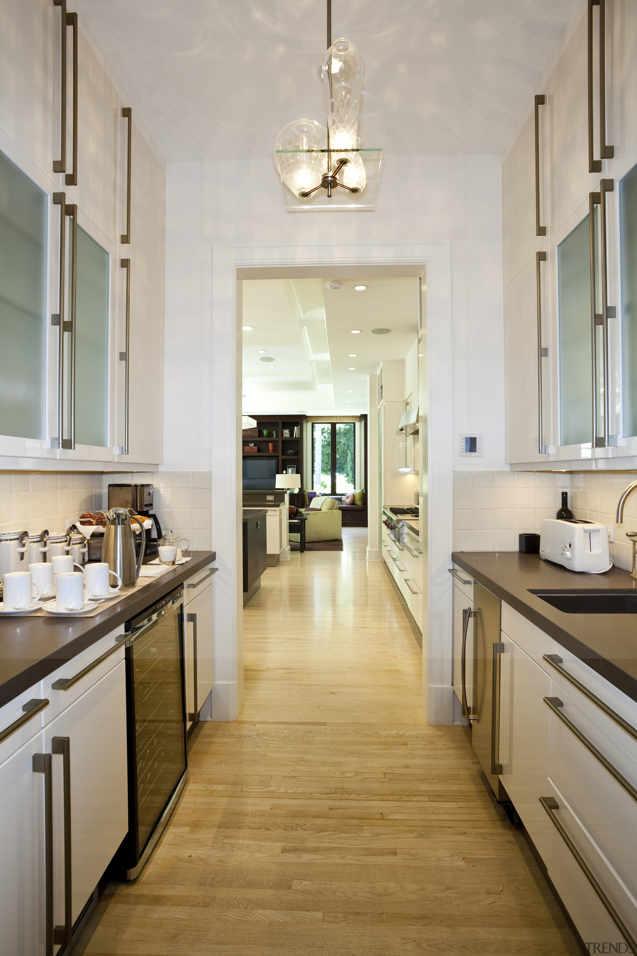 View of contemporary kitchen wooden flooring, dark cabinetry cabinetry, countertop, cuisine classique, floor, flooring, hardwood, home, interior design, kitchen, room, wood flooring, gray