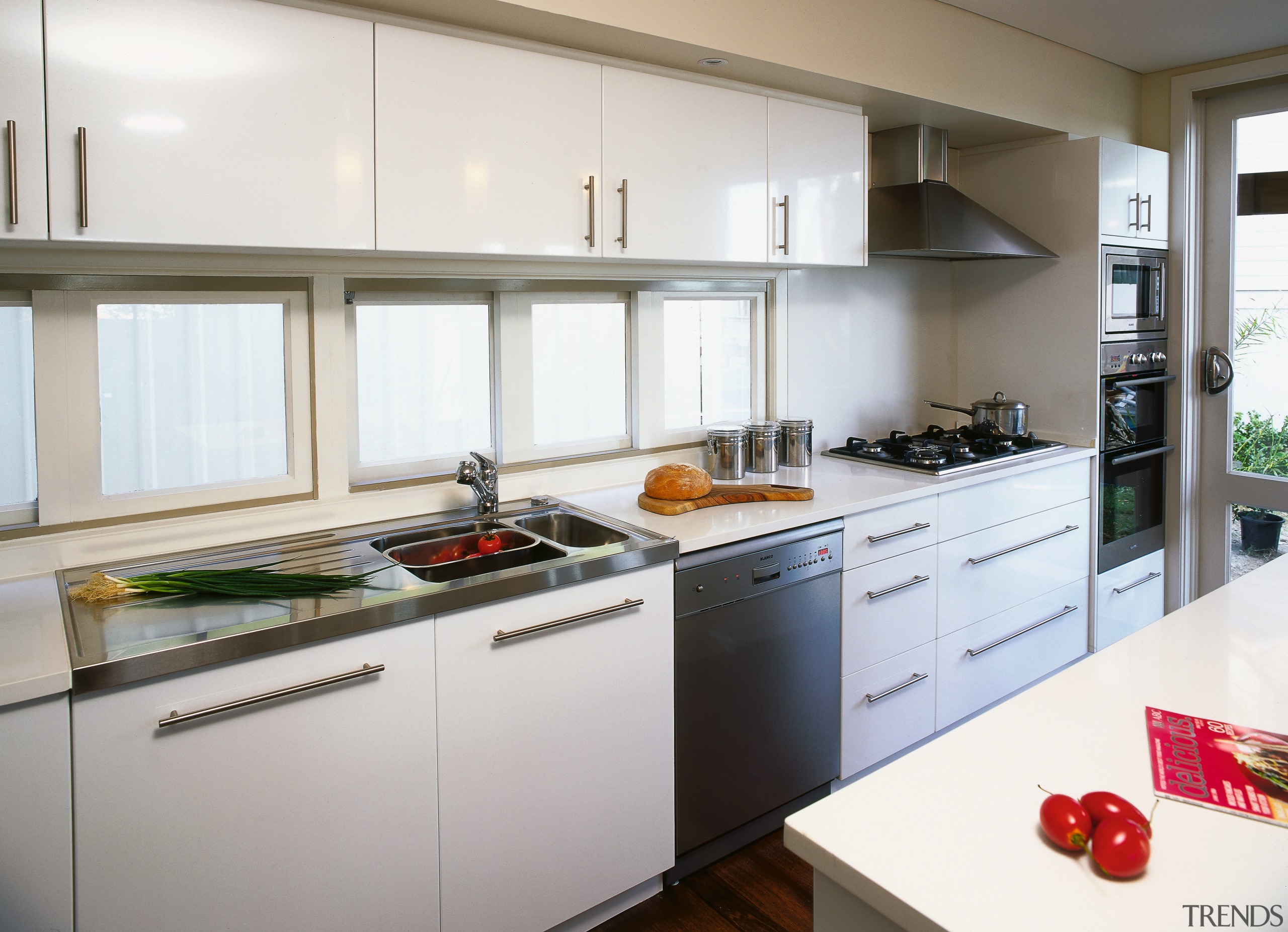 A view of a kitchen area, wooden flooring, cabinetry, countertop, cuisine classique, interior design, kitchen, real estate, white