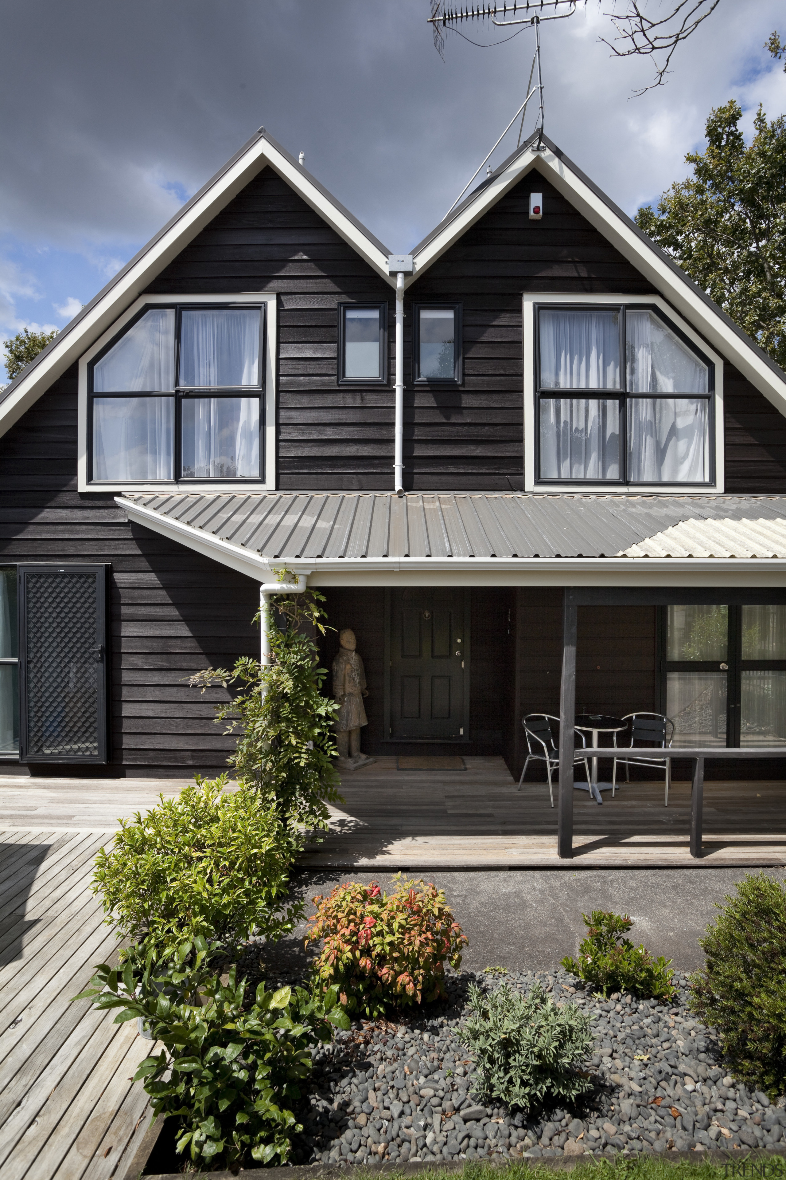 View of brown timber house with small front building, cottage, elevation, facade, farmhouse, home, house, neighbourhood, property, real estate, residential area, siding, suburb, window, gray, black