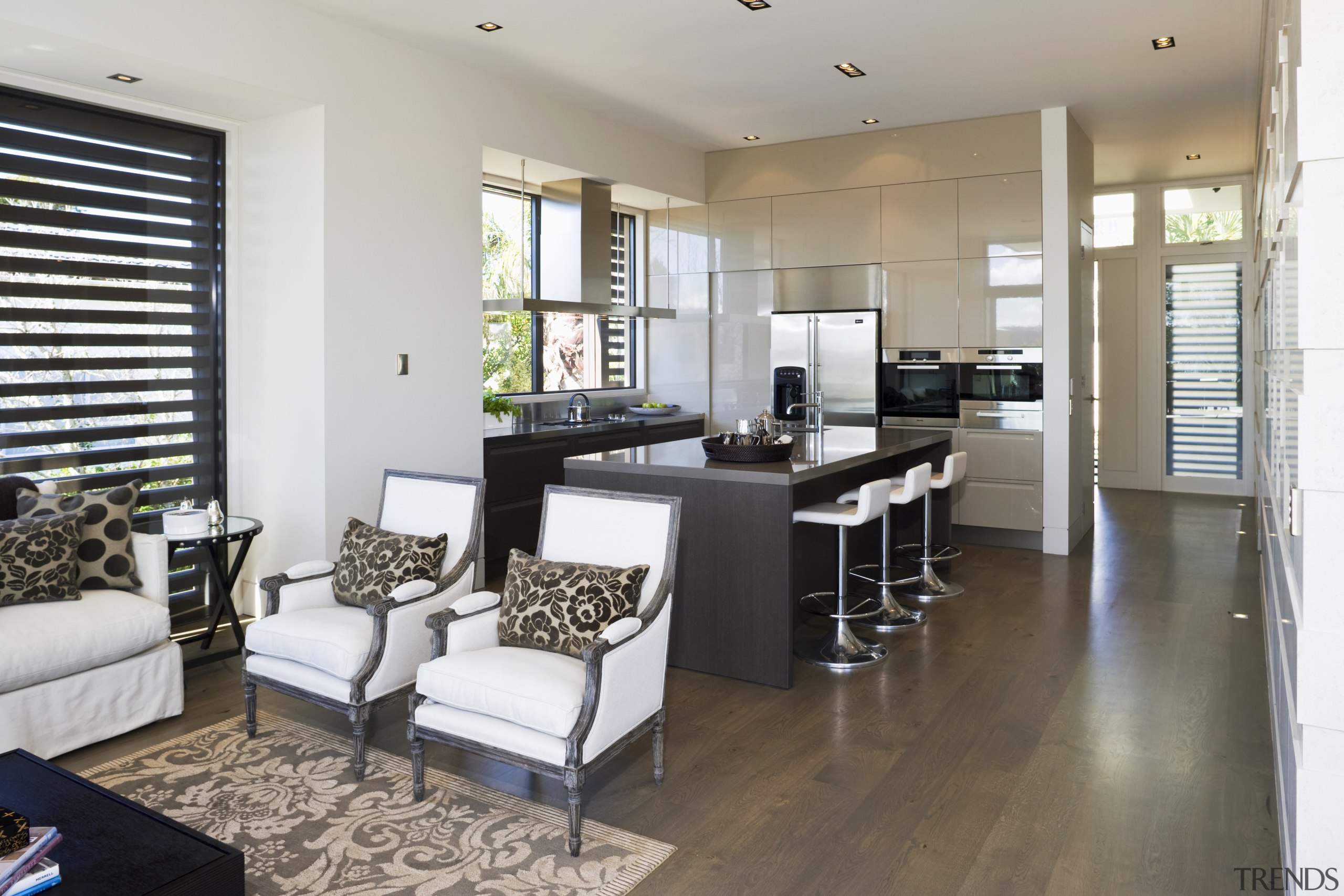 View of the kitchen area which faces into floor, flooring, interior design, living room, property, real estate, room, gray