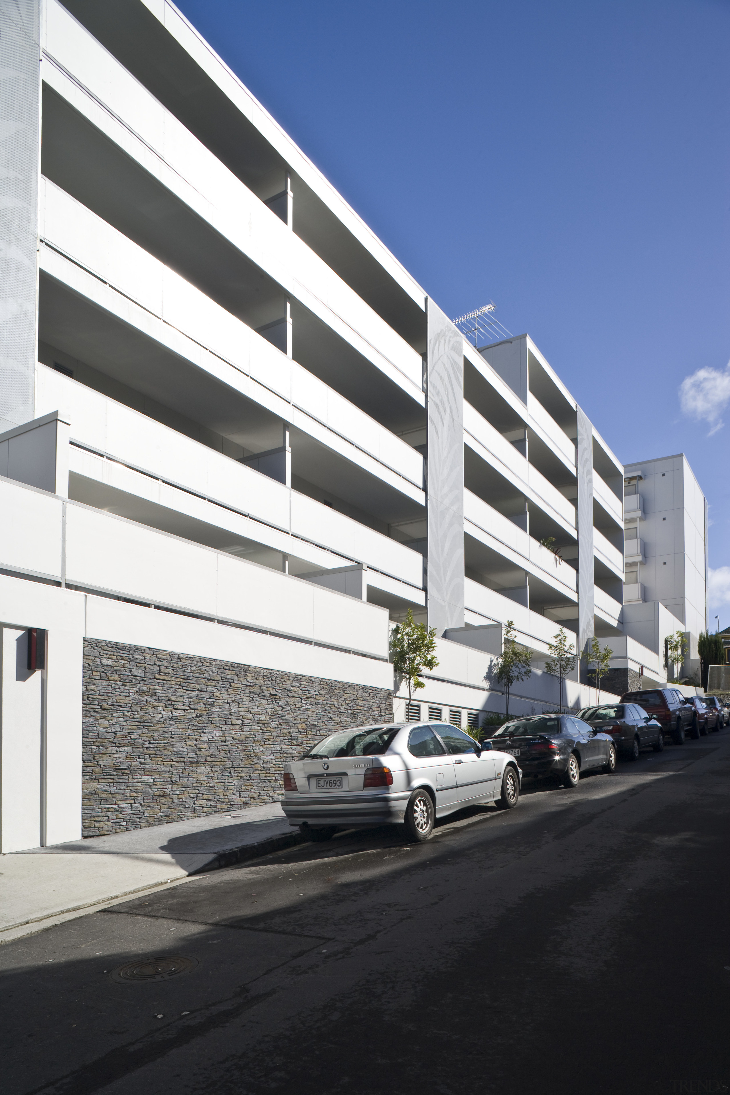 Exterior view of the Ivory apartments which features apartment, architecture, building, commercial building, condominium, corporate headquarters, facade, headquarters, house, metropolitan area, mixed use, motor vehicle, parking, parking lot, property, residential area, sky, black, white