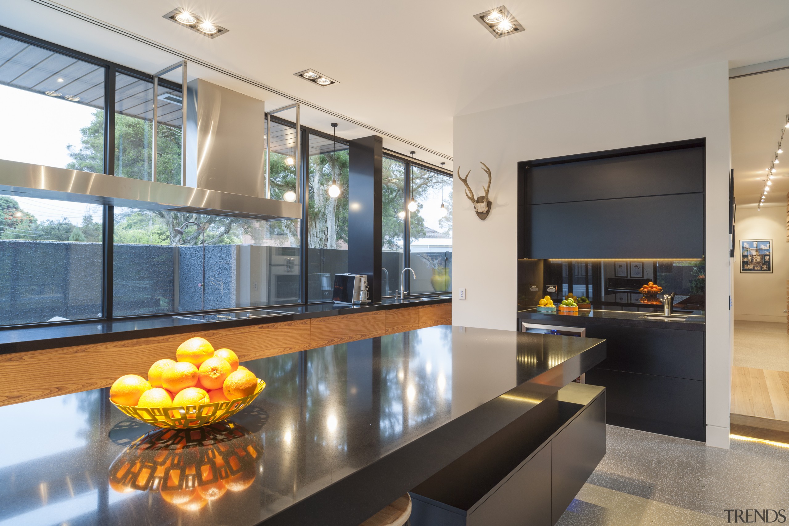 The cantilevered island countertop echoes the custom stainless interior design, kitchen, living room, real estate, window, gray