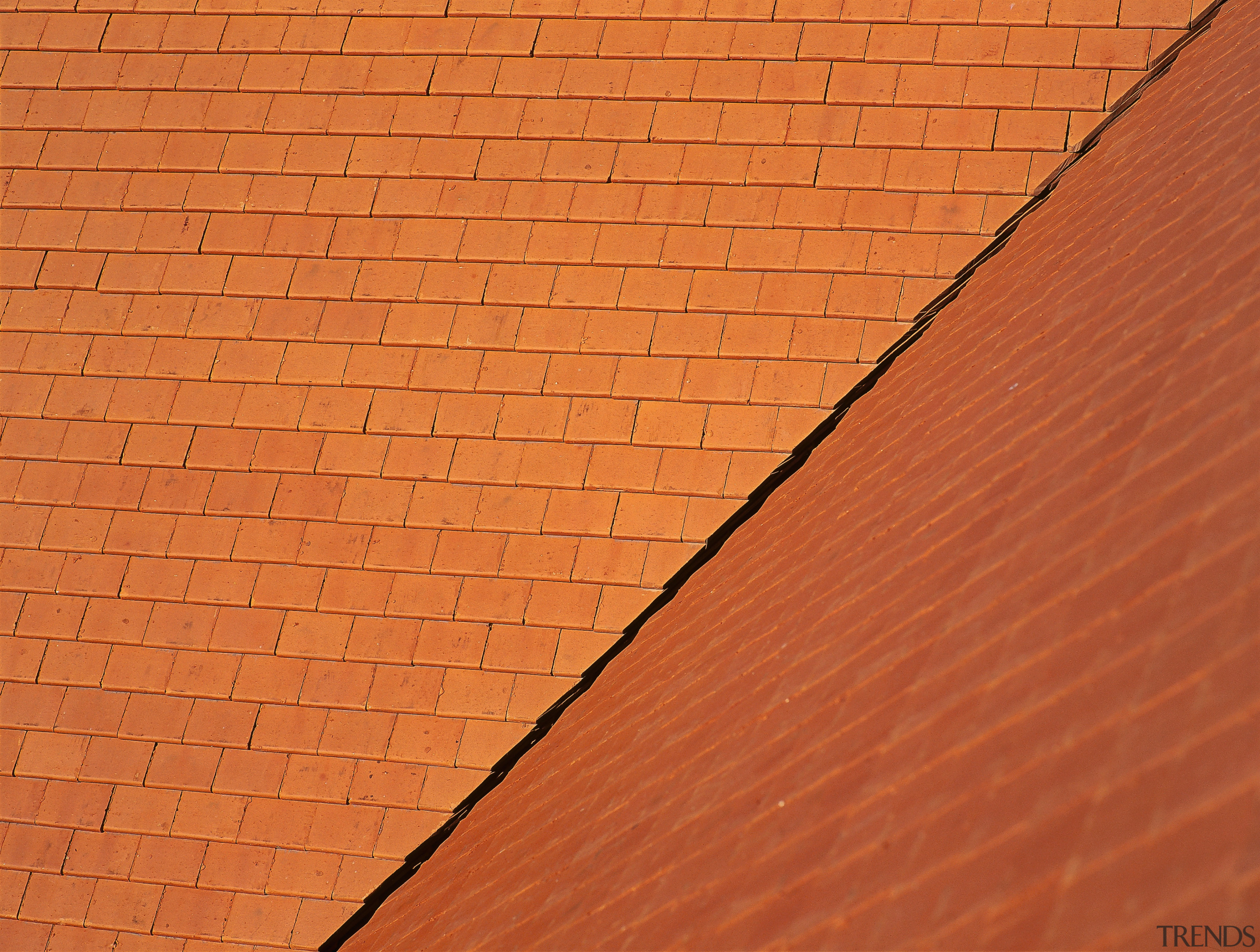 Steeply pitched roof with terracotta roof tiles, with angle, brick, brickwork, line, material, orange, roof, sky, wall, wood, wood stain, orange