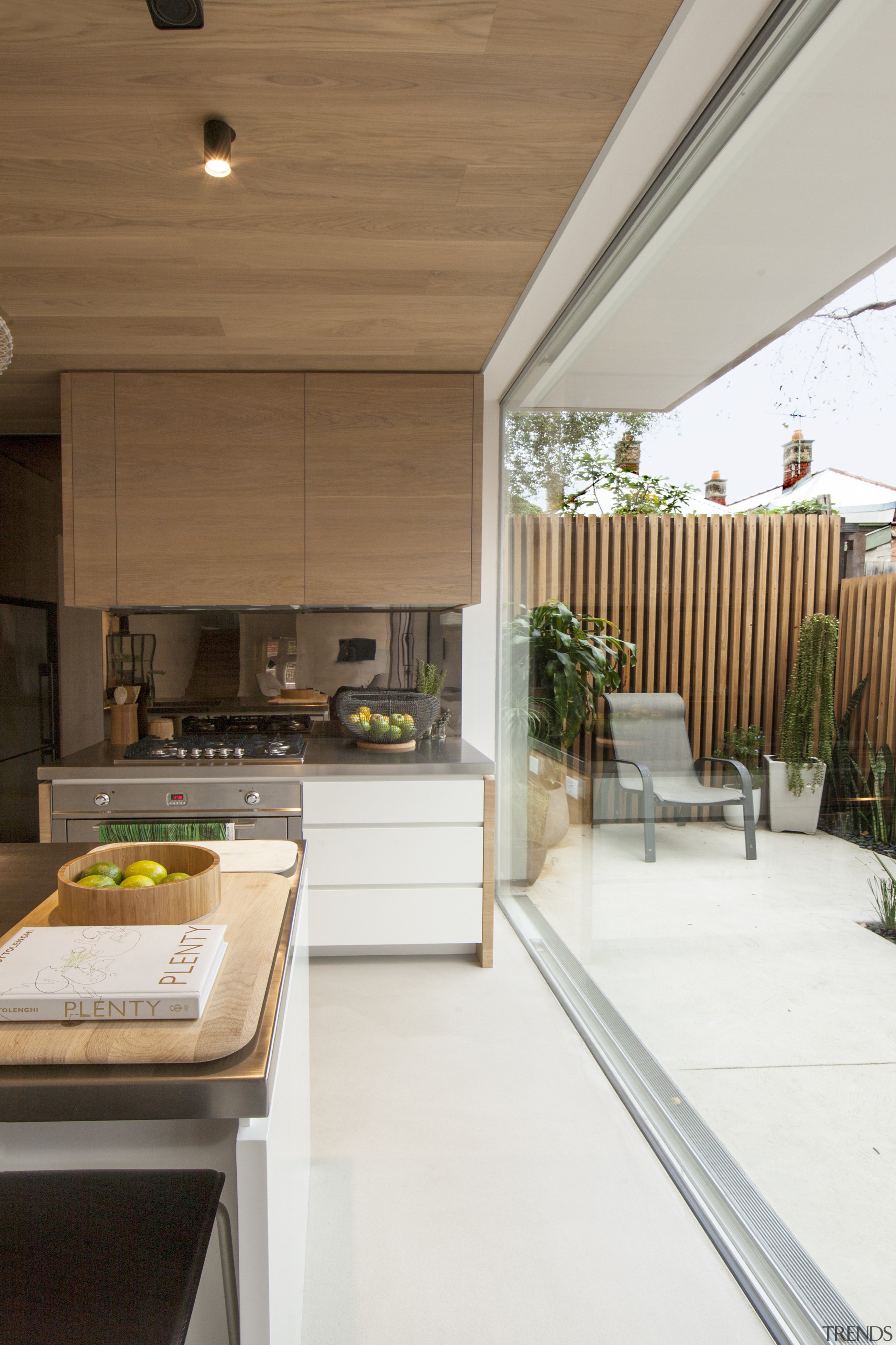 With plenty of room to move behind the architecture, ceiling, countertop, daylighting, home, house, interior design, kitchen, real estate, roof, window, white, brown