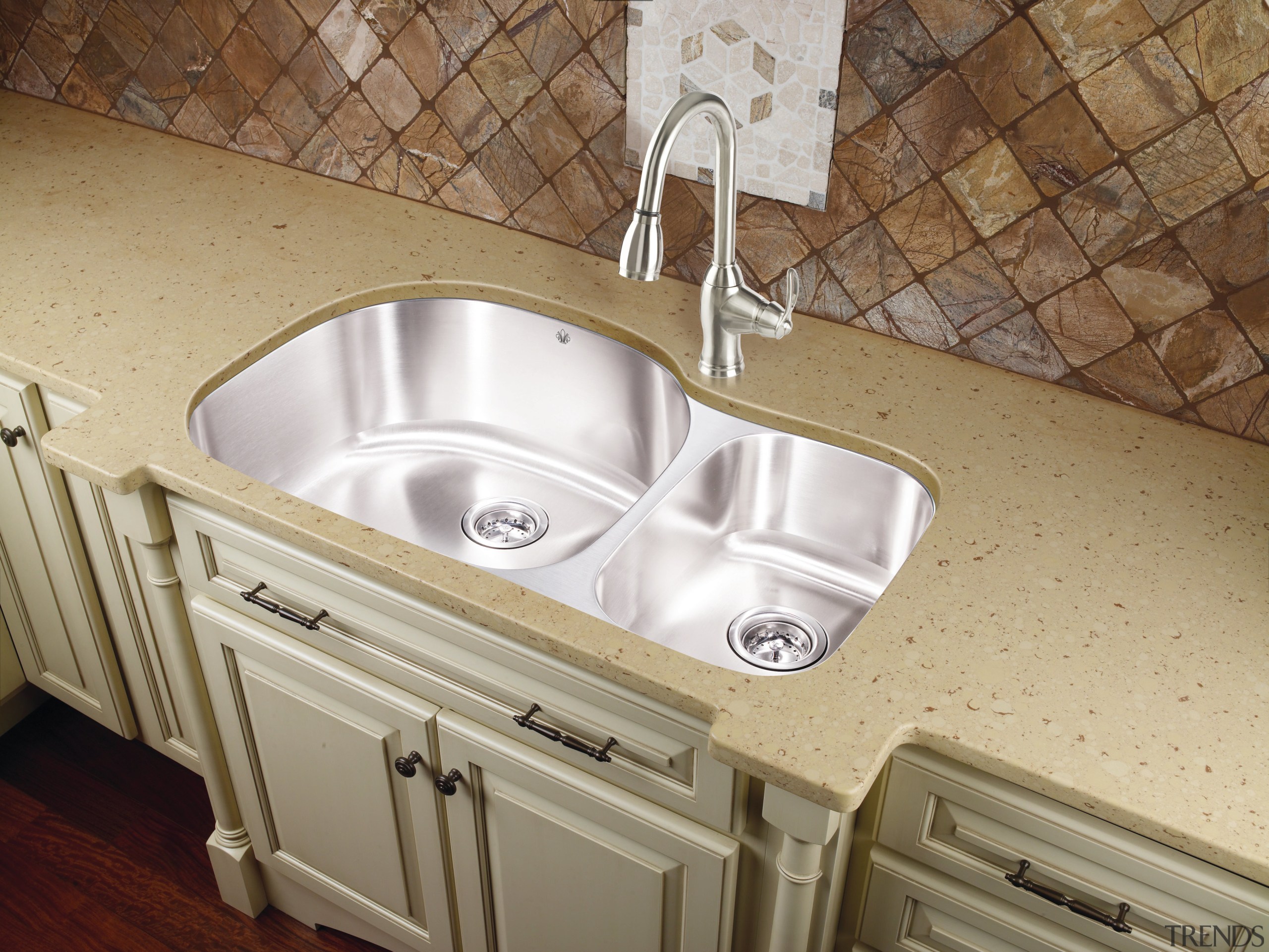 View of kitchen which features sink and arched bathroom sink, countertop, plumbing fixture, sink, tile, brown, gray